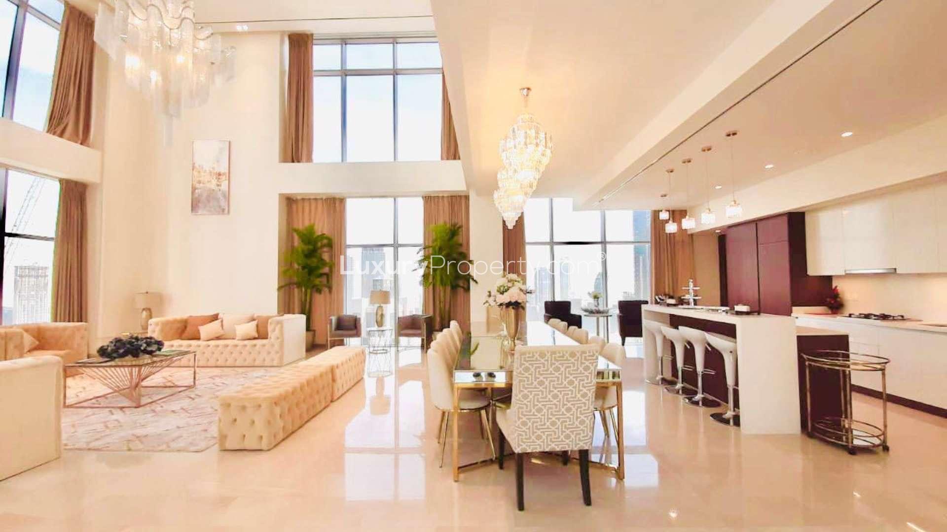 Elegant bedroom in split-level penthouse, Downtown Dubai, with city views through large windows