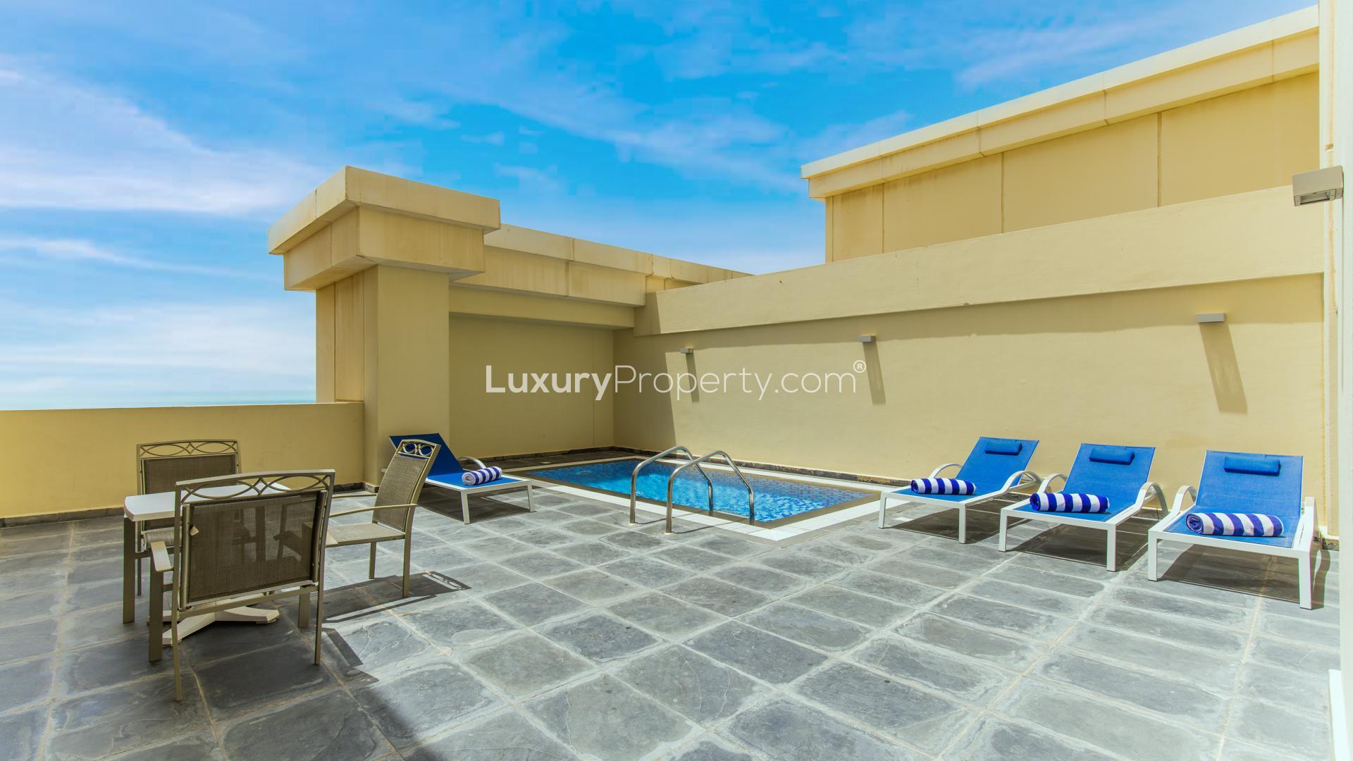 Luxurious living room in Jumeirah Beach penthouse with plush sofas and pool table