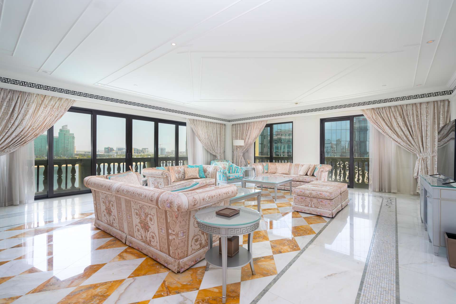 Furnished living room in Palazzo Versace apartment, Culture Village, with creek view and elegant decor
