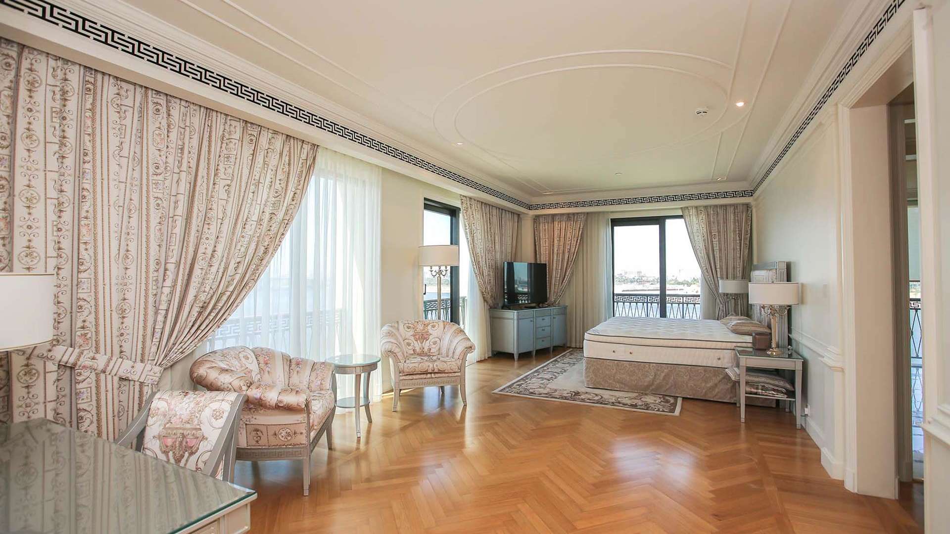 Outdoor pool area at Palazzo Versace apartment in Culture Village, Dubai. Luxurious amenities featured