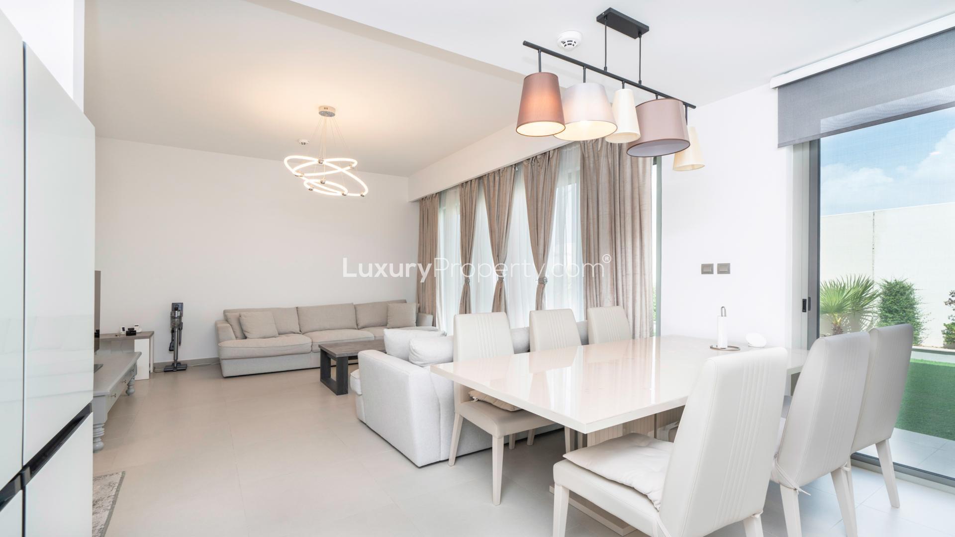 Outdoor garden area with seating and swing in Arabian Ranches 2 townhouse