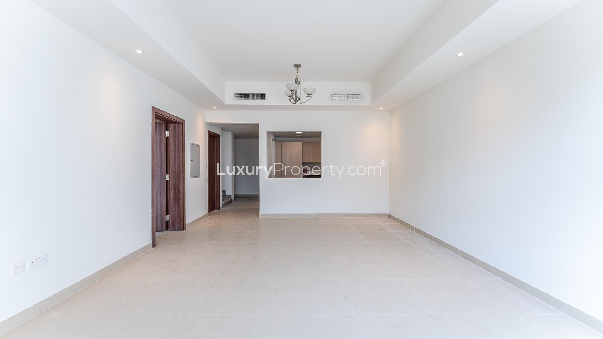 Townhouse backyard with artificial grass and paved patio in Senses at The Fields, MBR City