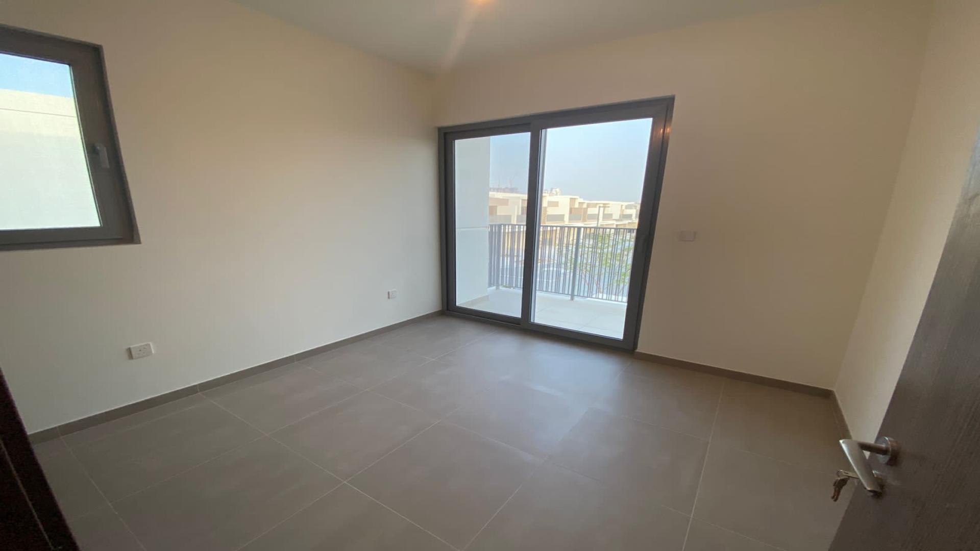 Spacious living room with large windows in Elan townhouse, Tilal Al Ghaf community