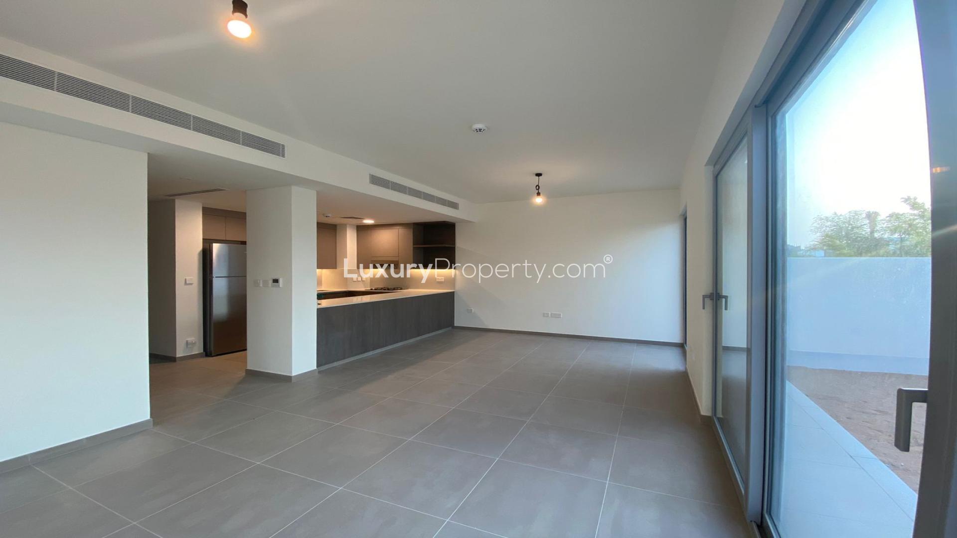 Empty bedroom with large window, tiled floor, and balcony view in Elan, Tilal Al Ghaf townhouse
