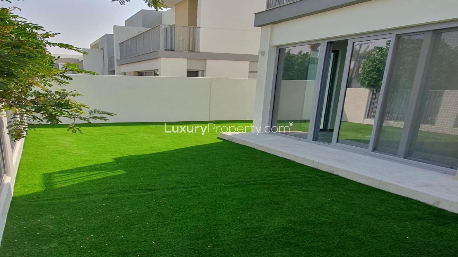 Modern open-plan kitchen and living area in Tilal Al Ghaf townhouse for rent
