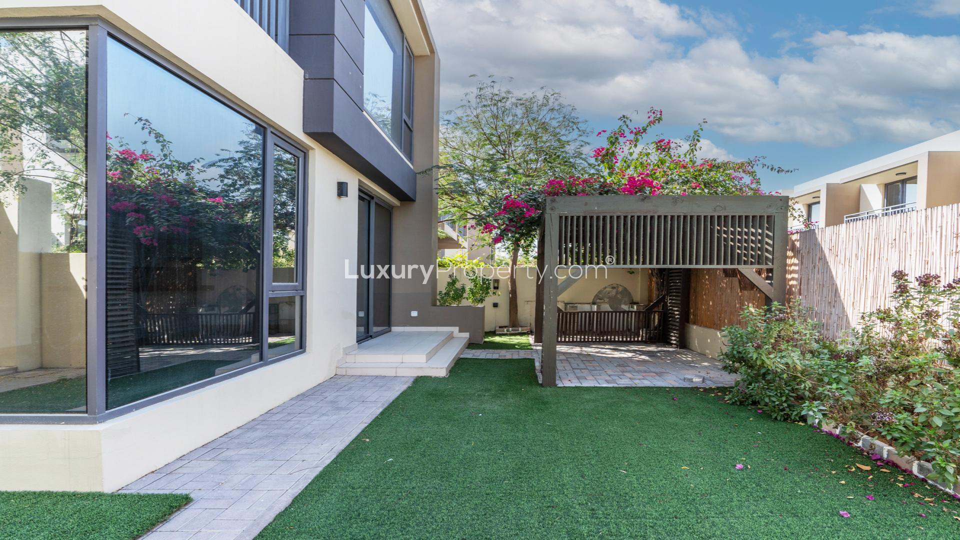 Contemporary townhouse exterior in Maple 2, Dubai Hills Estate, featuring modern design and landscaping