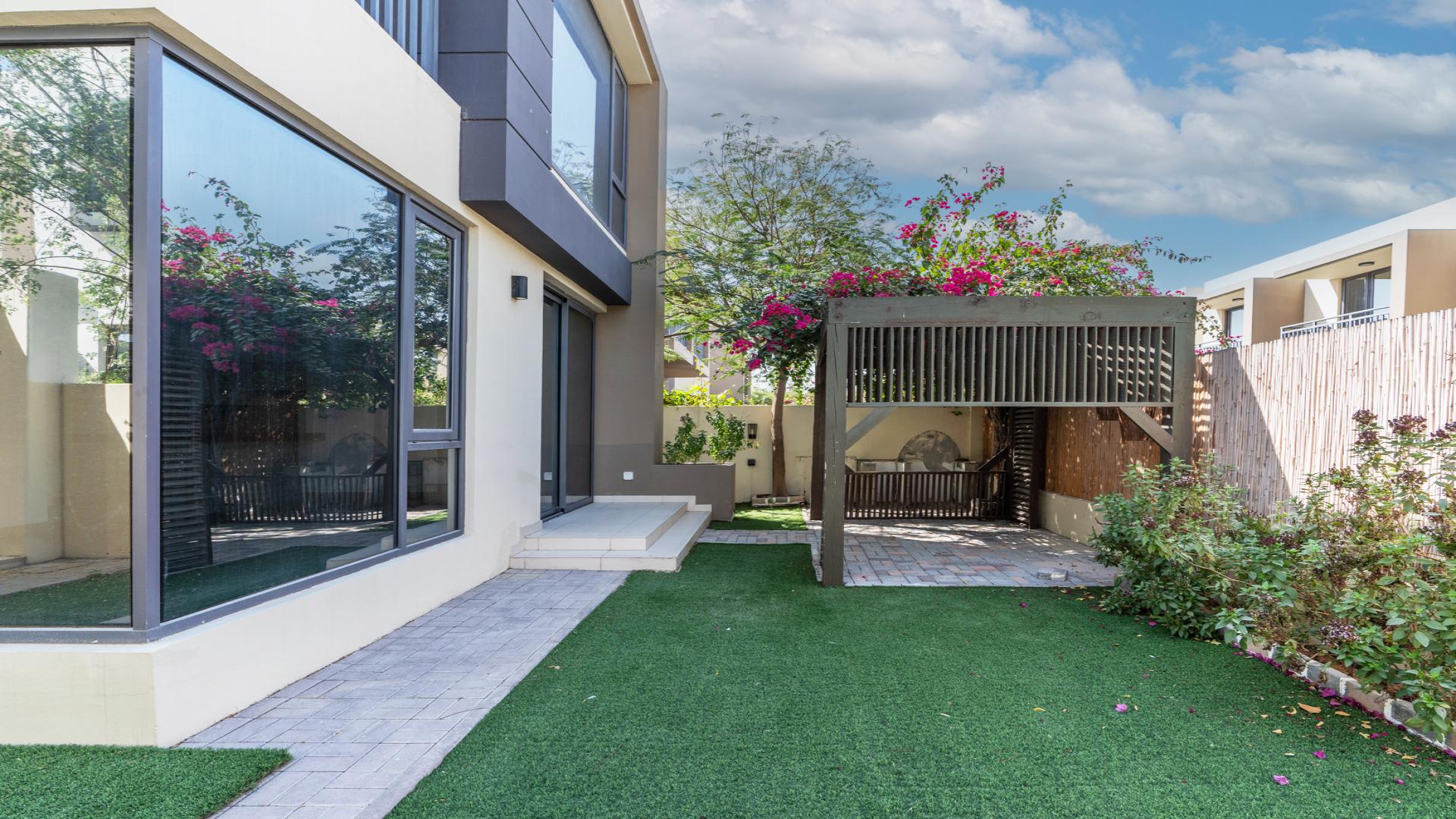 Contemporary townhouse exterior in Maple 2, Dubai Hills Estate, featuring modern design and landscaping