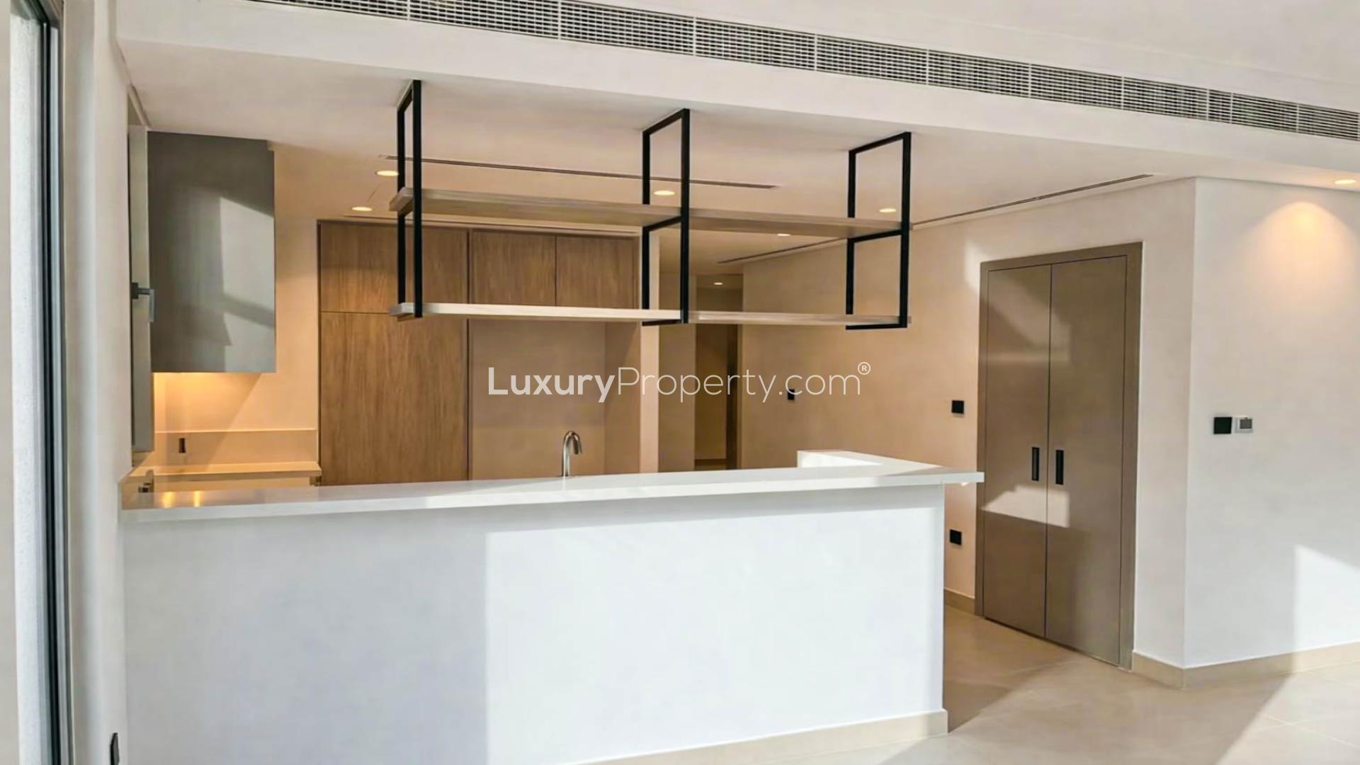 Bright open-plan kitchen and living area in Aura Gardens townhouse, Tilal Al Ghaf