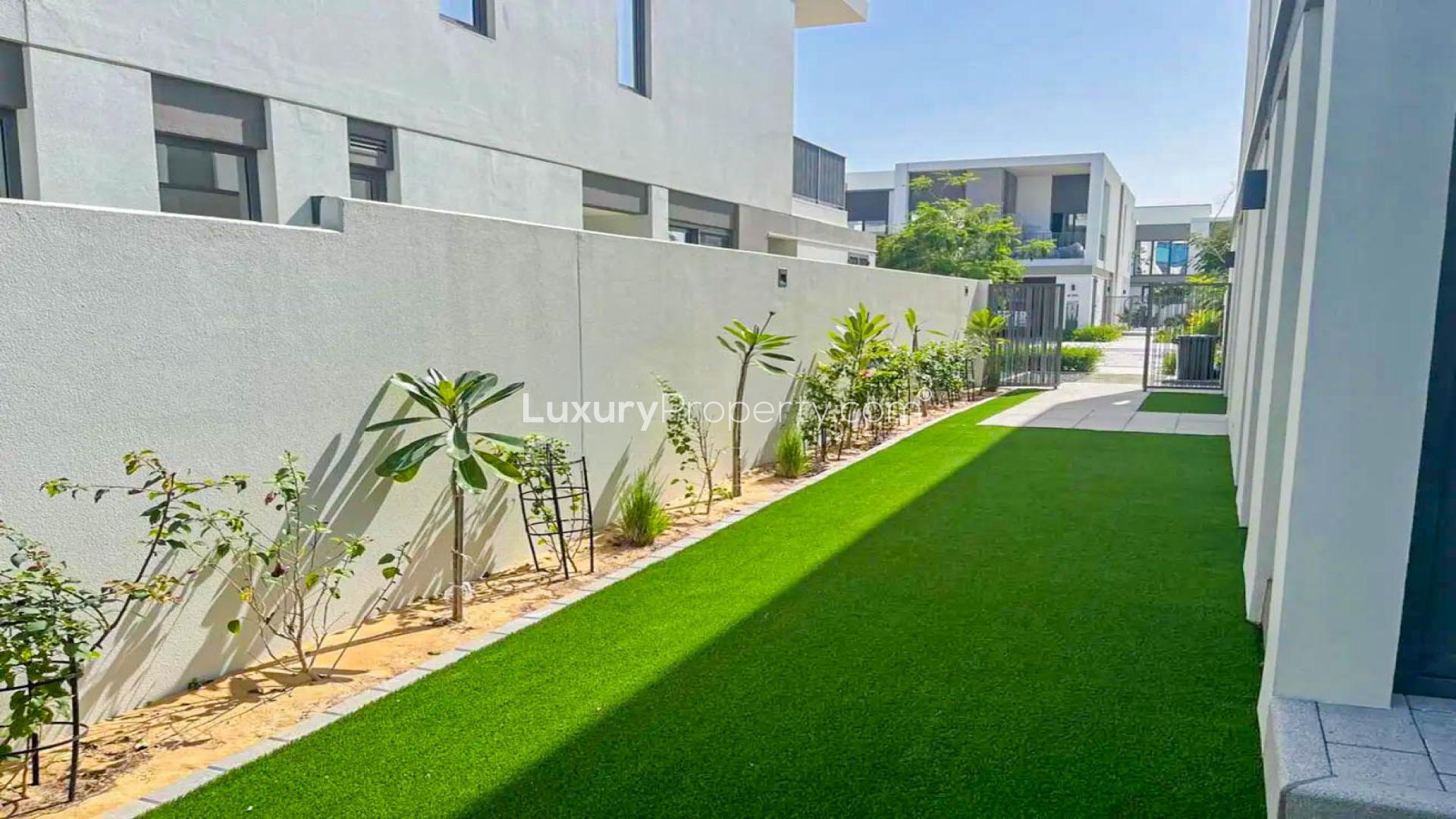 Beautifully landscaped backyard of a single row townhouse in Aura Gardens, Tilal Al Ghaf