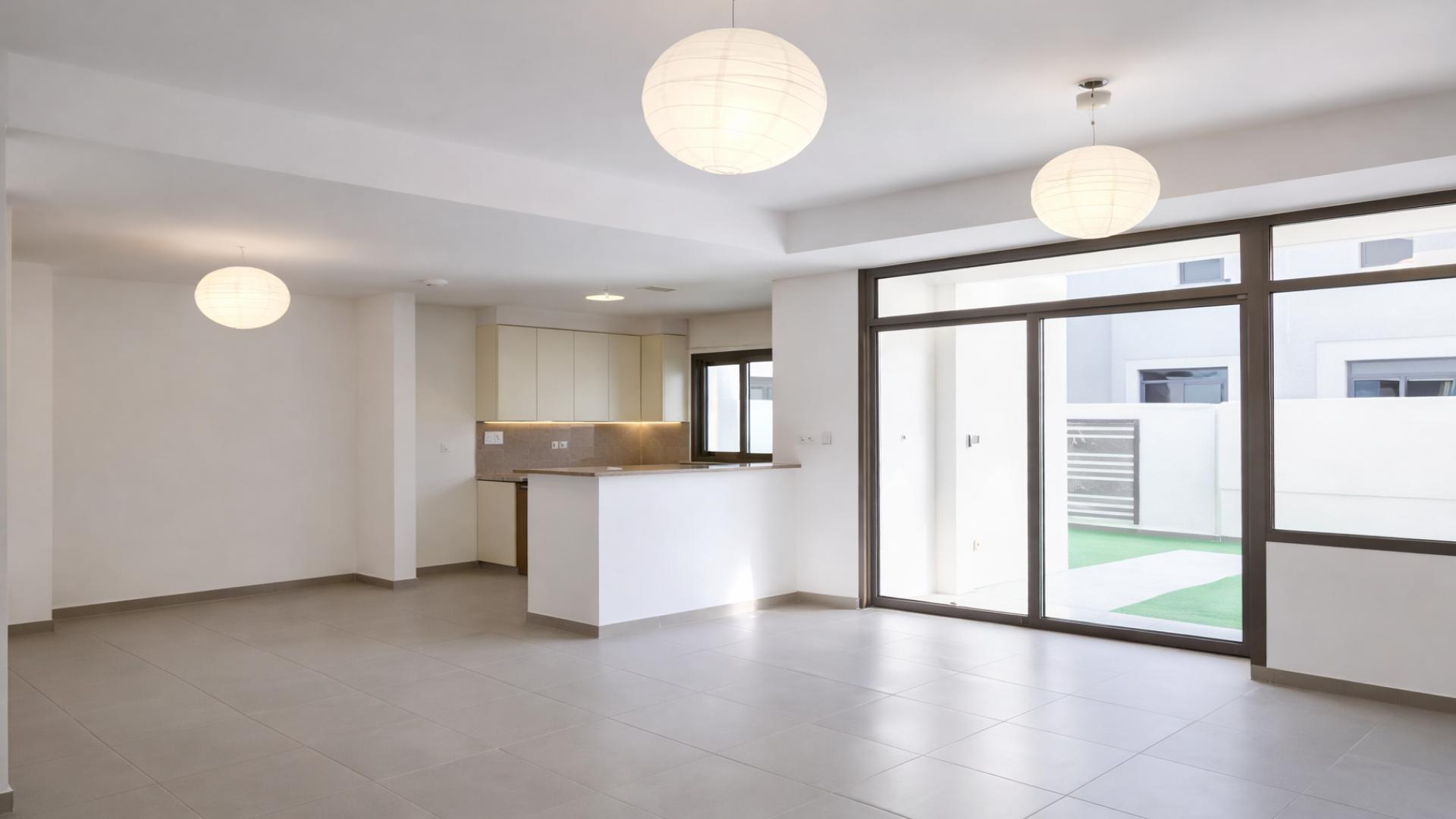 Modern townhouse exterior with private yard in Shams Townhouses, Town Square, for rent