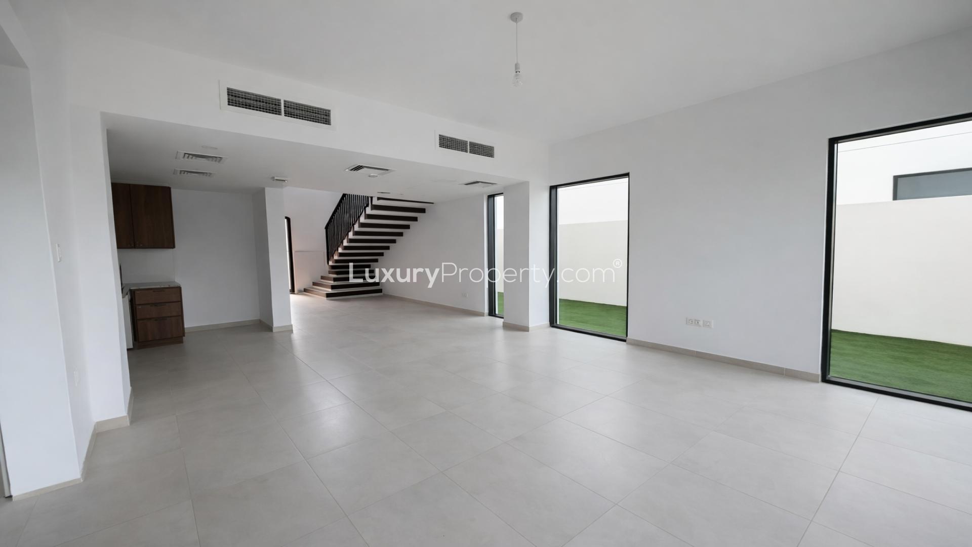 Bright, spacious bedroom with large windows in Shams Townhouses, Town Square, for rent