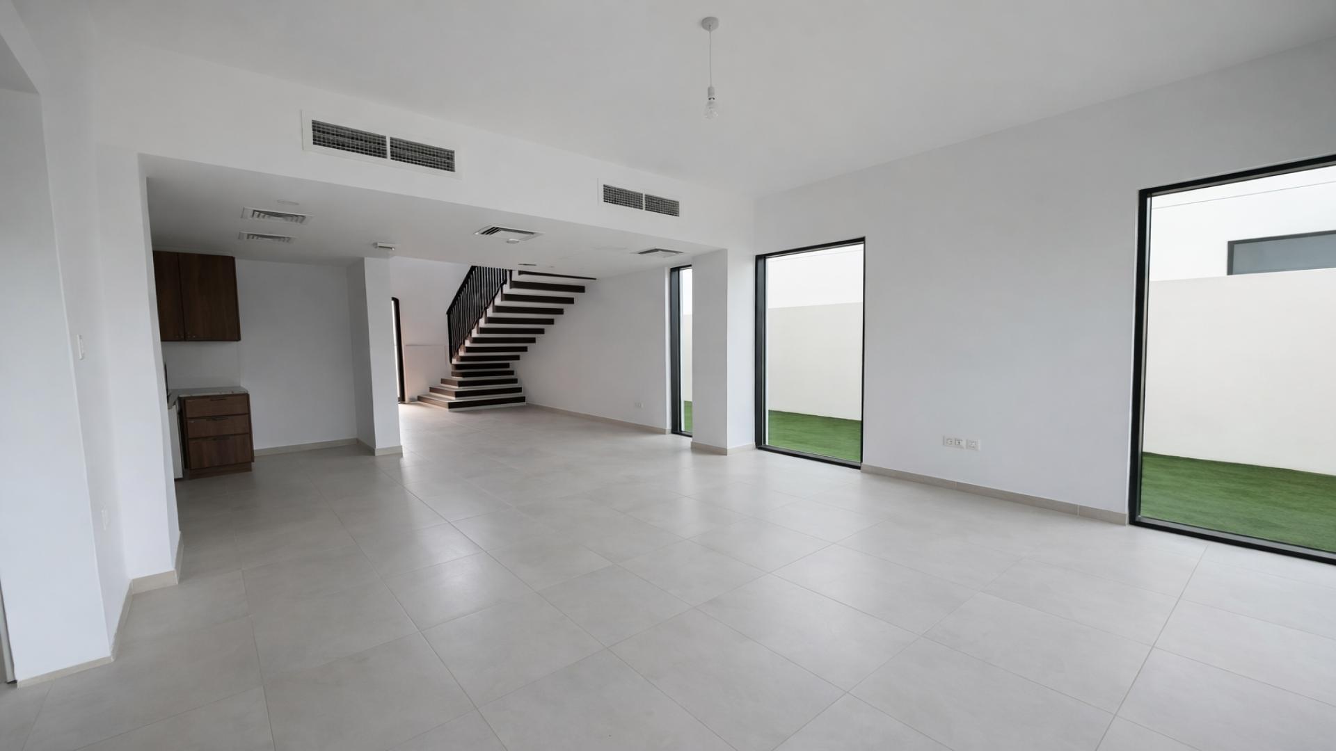 Bright, spacious bedroom with large windows in Shams Townhouses, Town Square, for rent