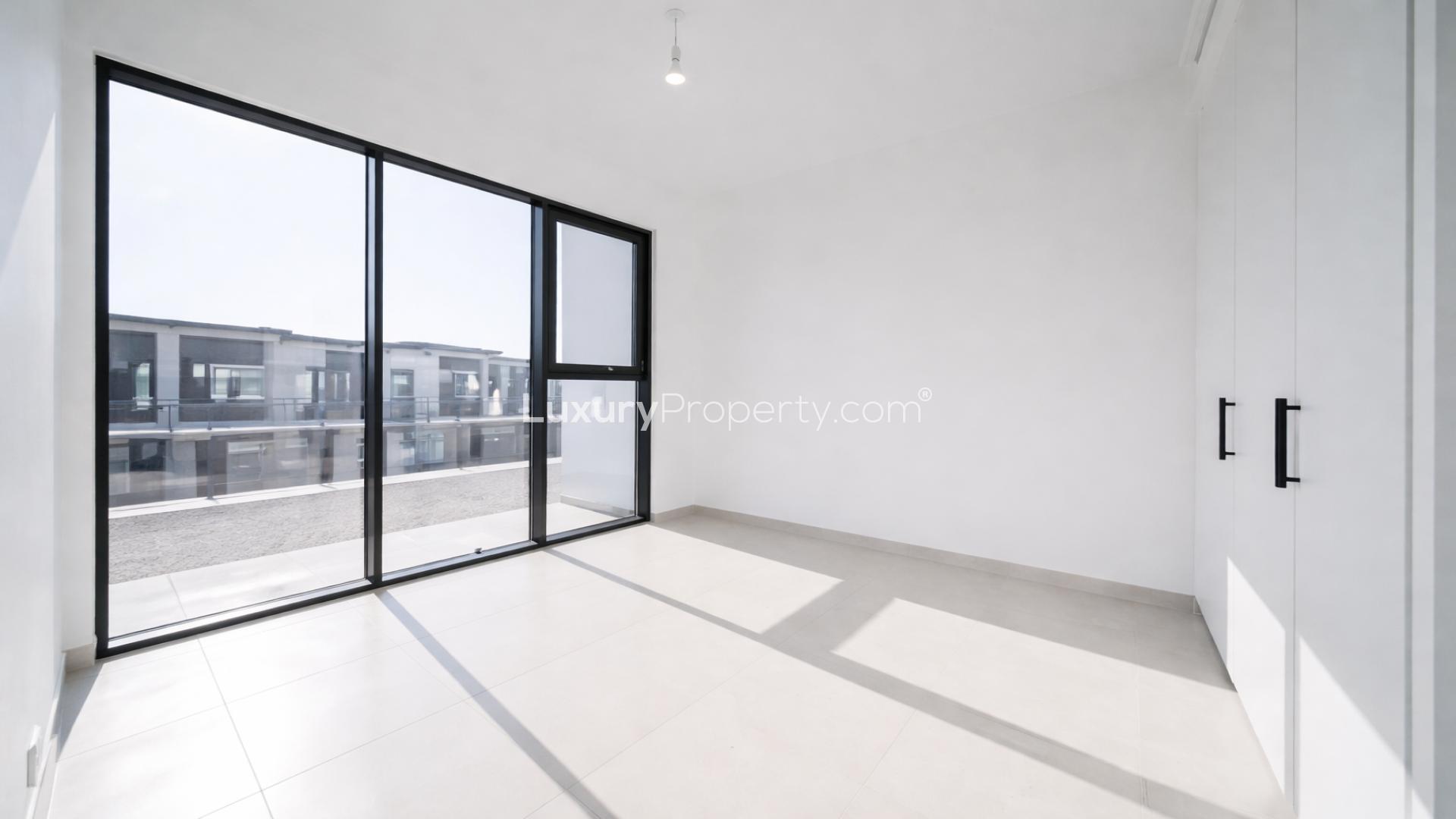 Modern open-plan kitchen and living area in Shams Townhouses, Town Square, for rent