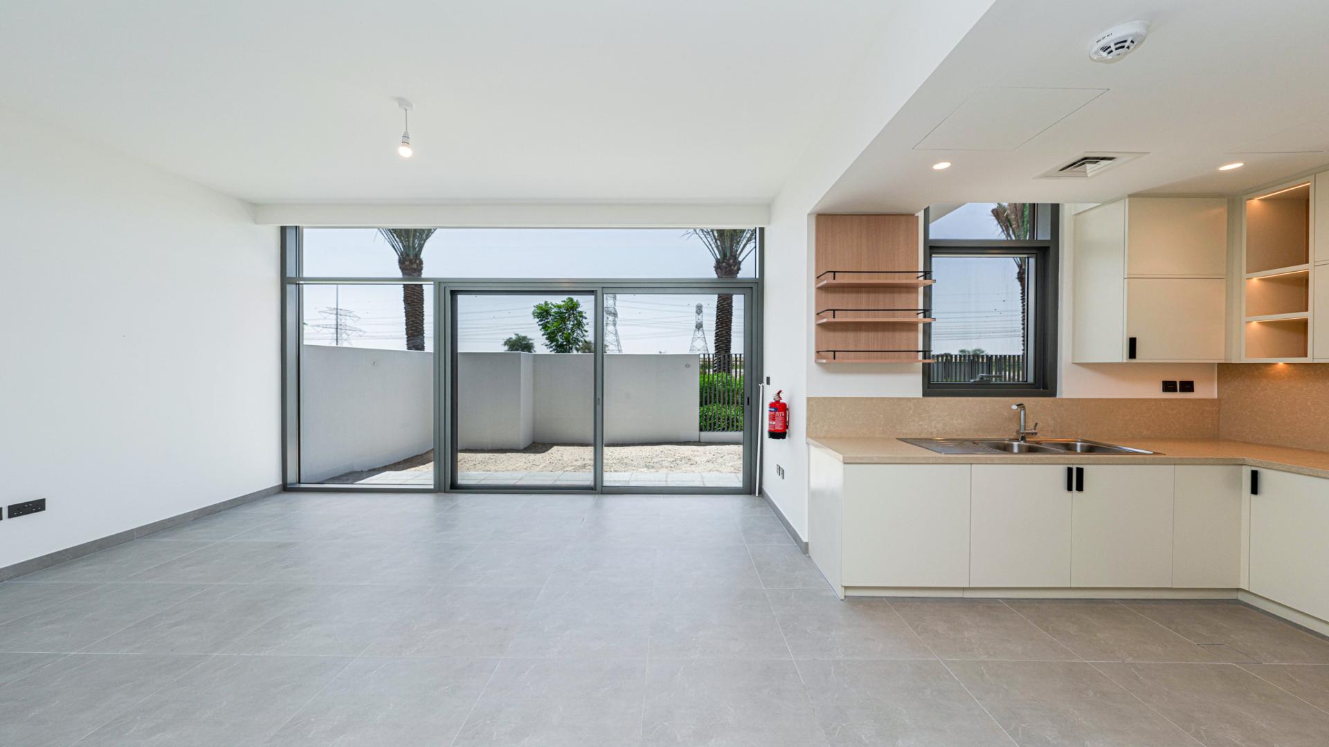 Modern open-plan kitchen and living area in Ruba townhouse, Arabian Ranches 3