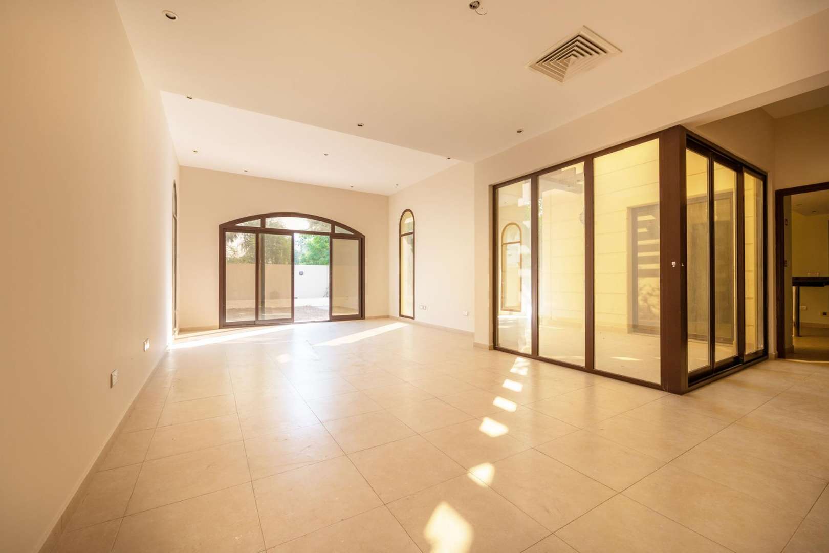Spacious living room in 4-bedroom townhouse, Al Salam, Mudon, with large windows and natural light