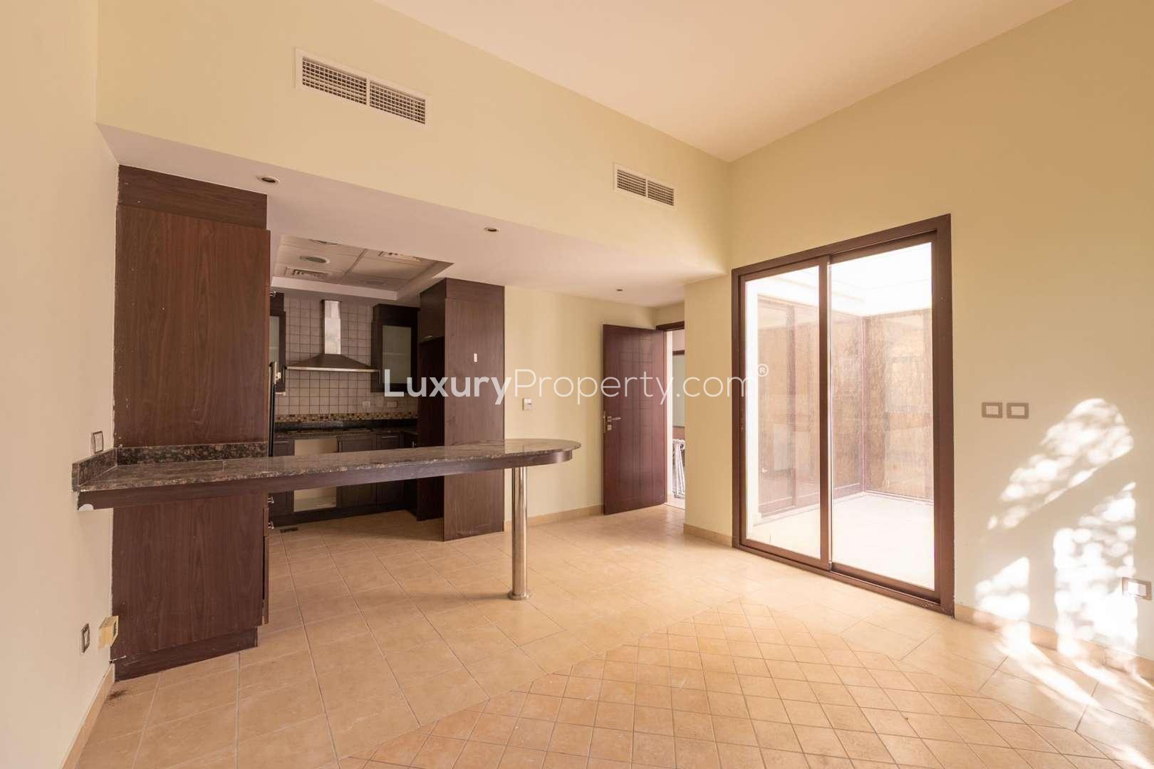 Spacious living room in Mudon townhouse with large windows, tiled floor, natural light