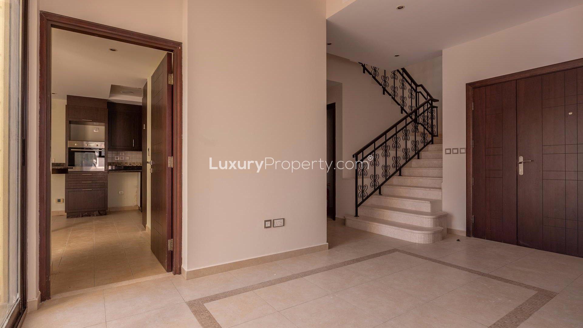 Interior of Mudon Al Salam townhouse with staircase and kitchen view