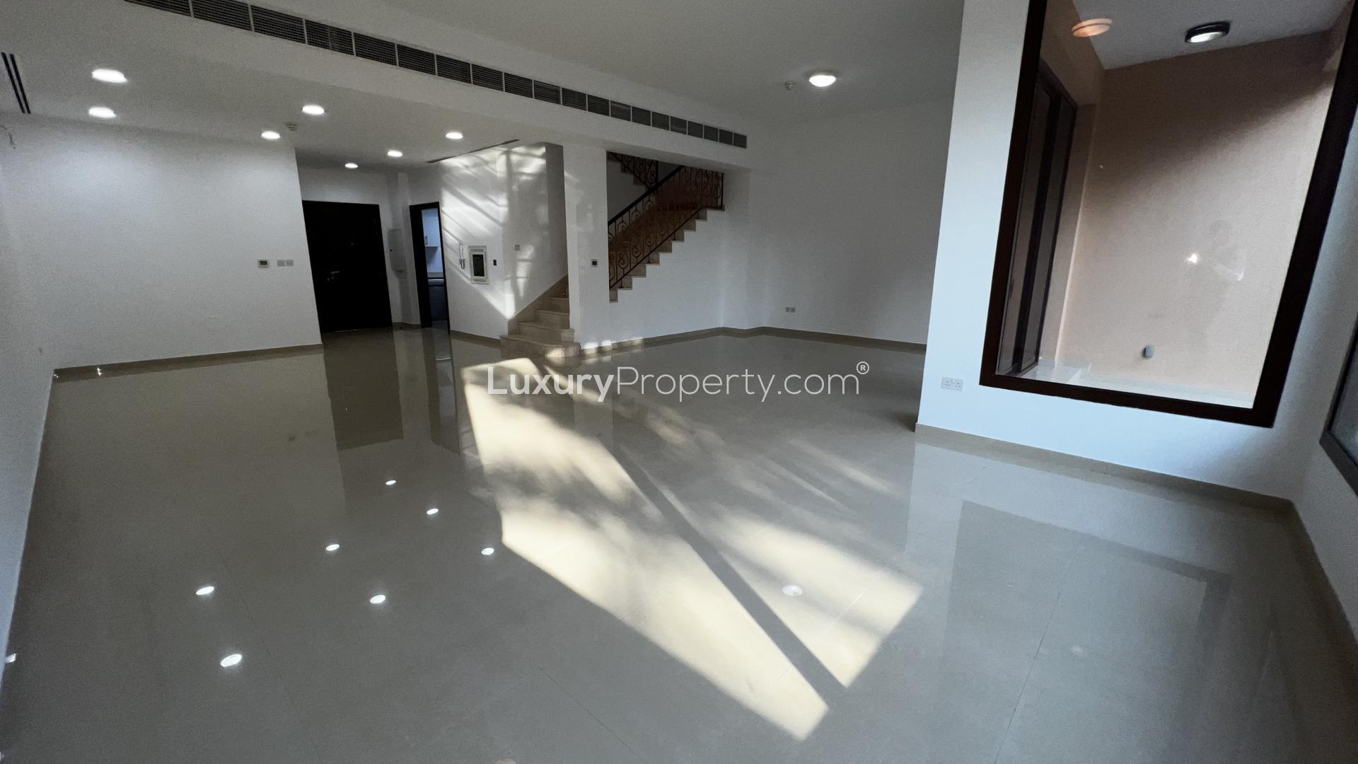 Spacious living area in 4-bedroom townhouse, Jumeirah Islands, with large windows and staircase