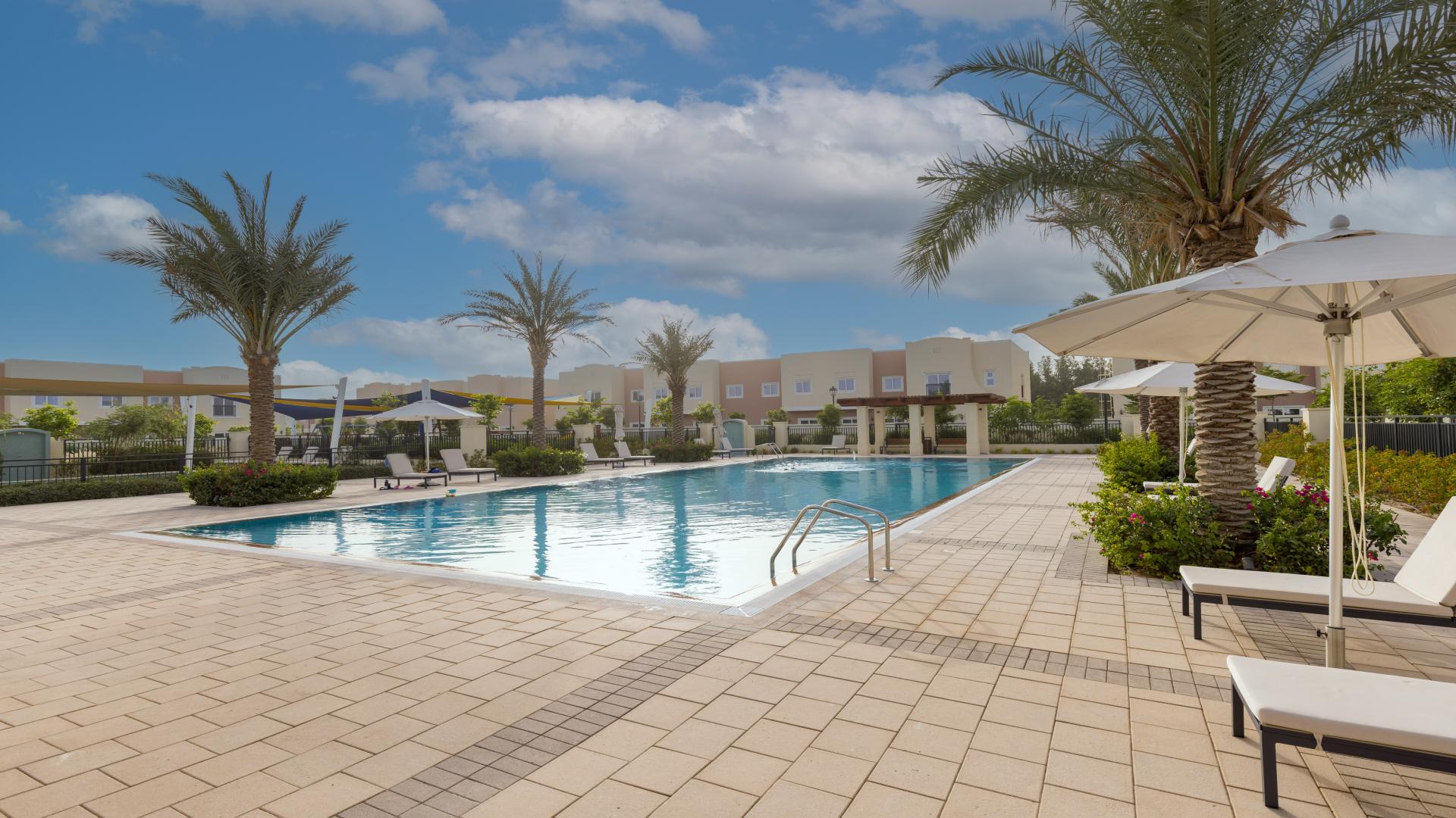 Spacious living area in Villanova townhouse, featuring modern staircase and natural light