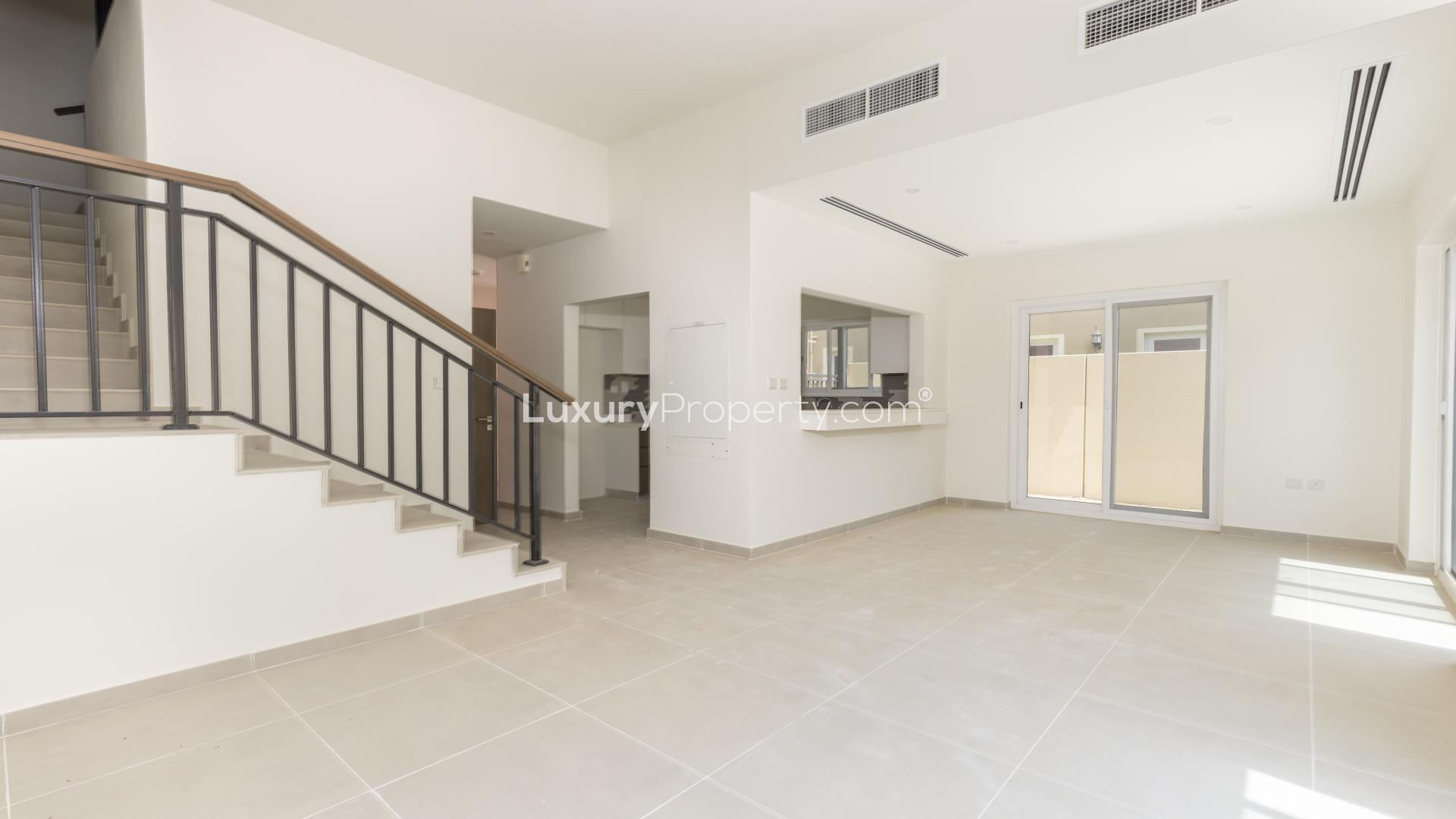 Pathway view between townhouses in Amaranta B, Villanova, with lush greenery