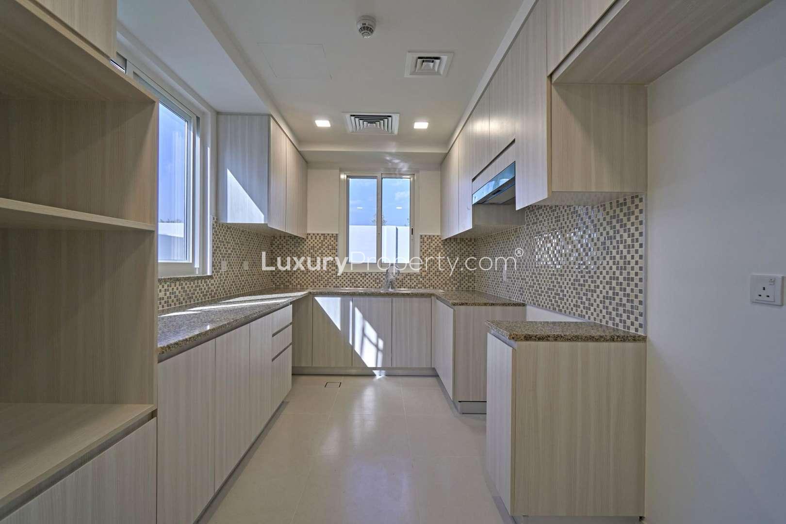 Elegant semi-detached townhouse exterior in Arabella 3, Mudon, with spacious driveway and garden