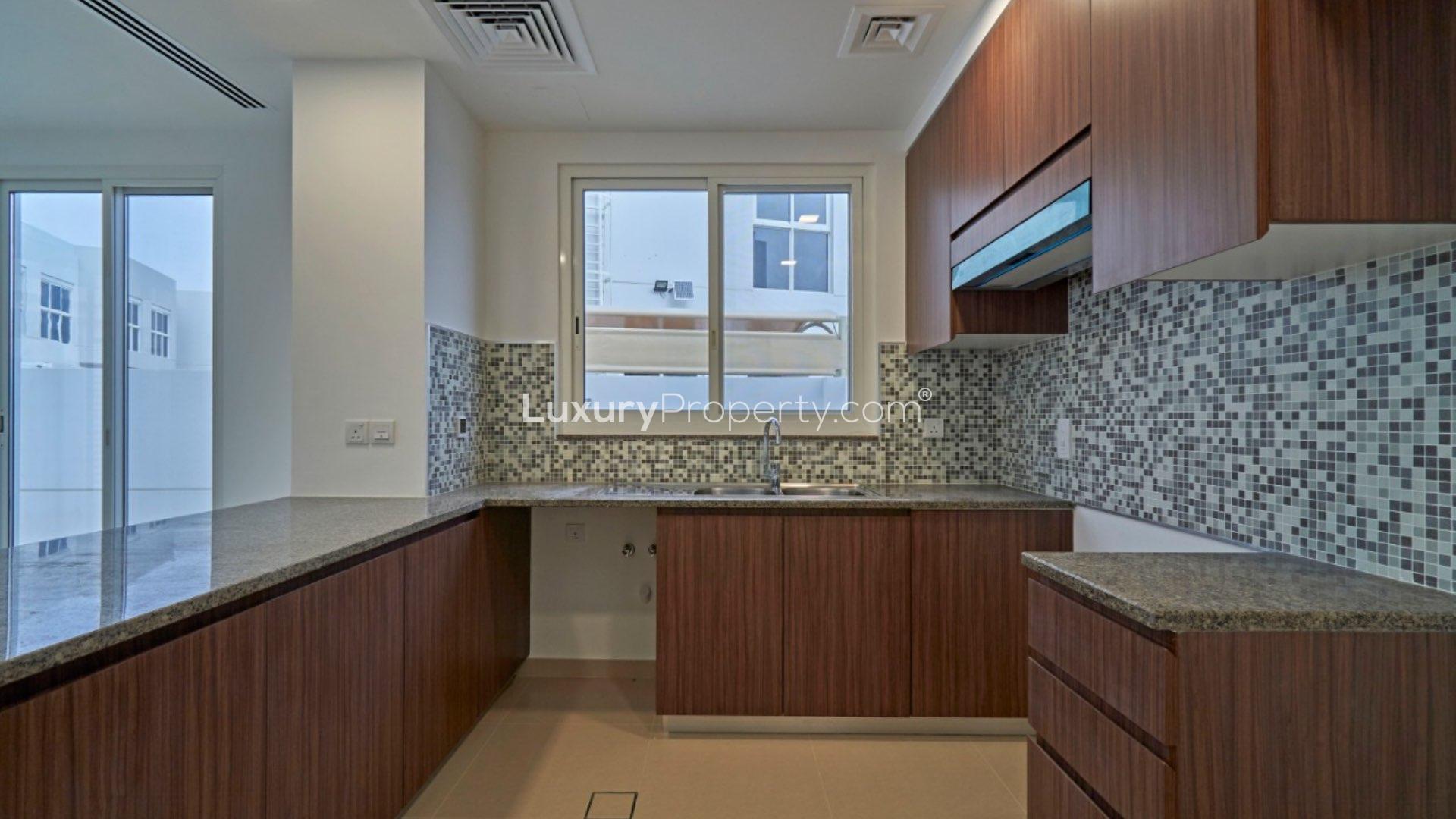 Spacious living area in 4-bedroom villa, Arabella Townhouses, Mudon, featuring modern staircase design