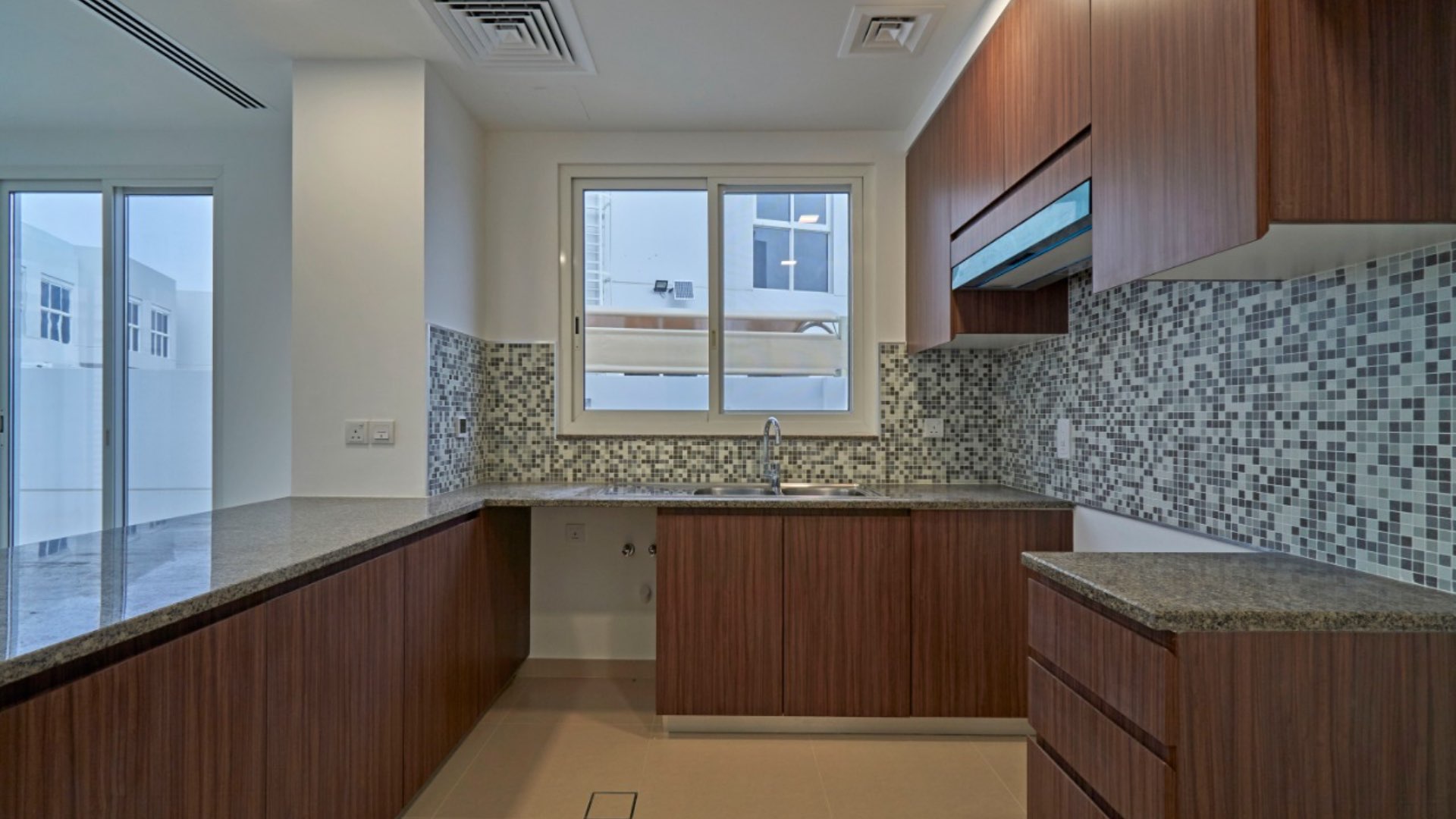 Spacious living area in 4-bedroom villa, Arabella Townhouses, Mudon, featuring modern staircase design
