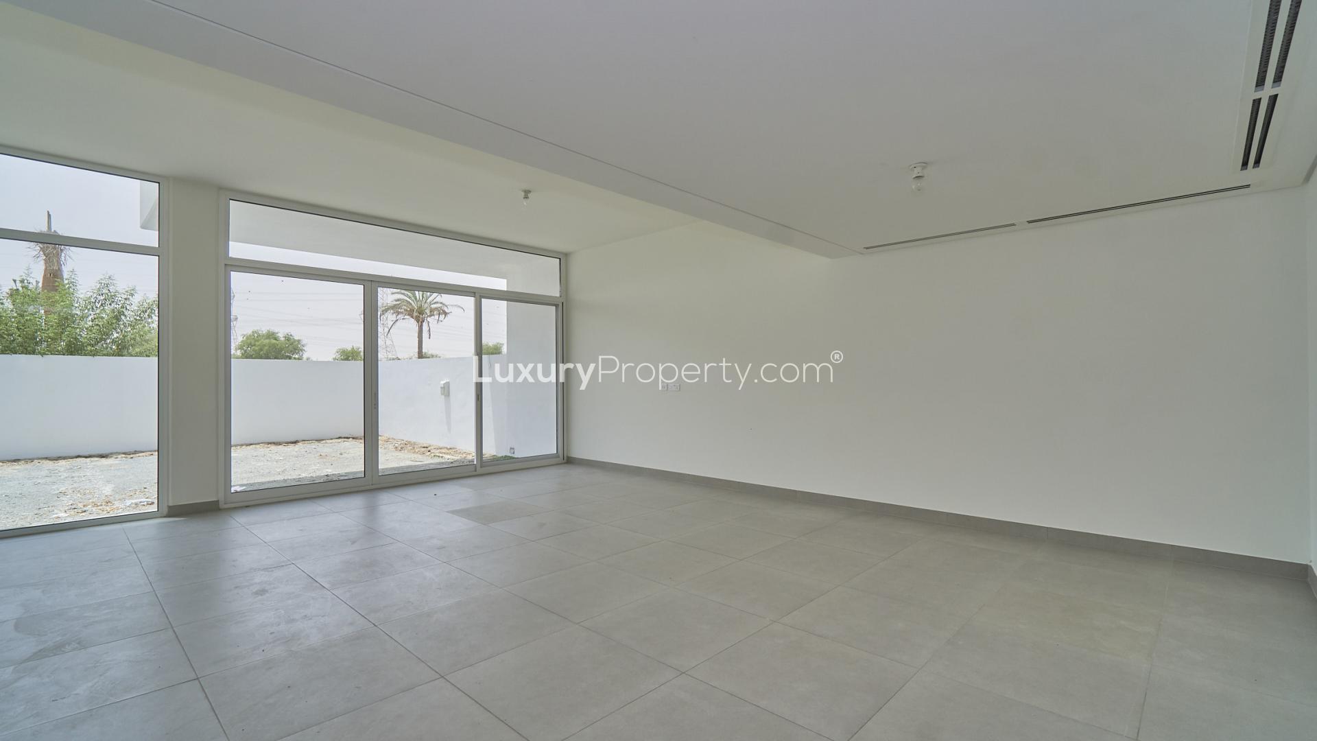 Empty living room with large windows in Arabella townhouse, Mudon community