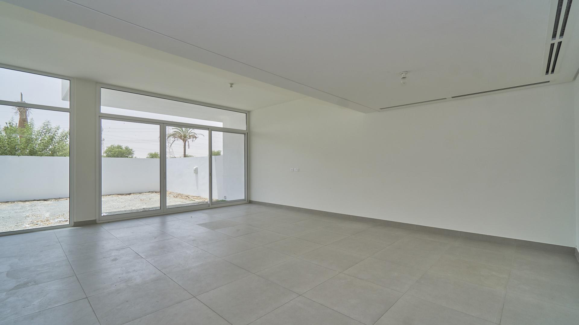 Empty living room with large windows in Arabella townhouse, Mudon community