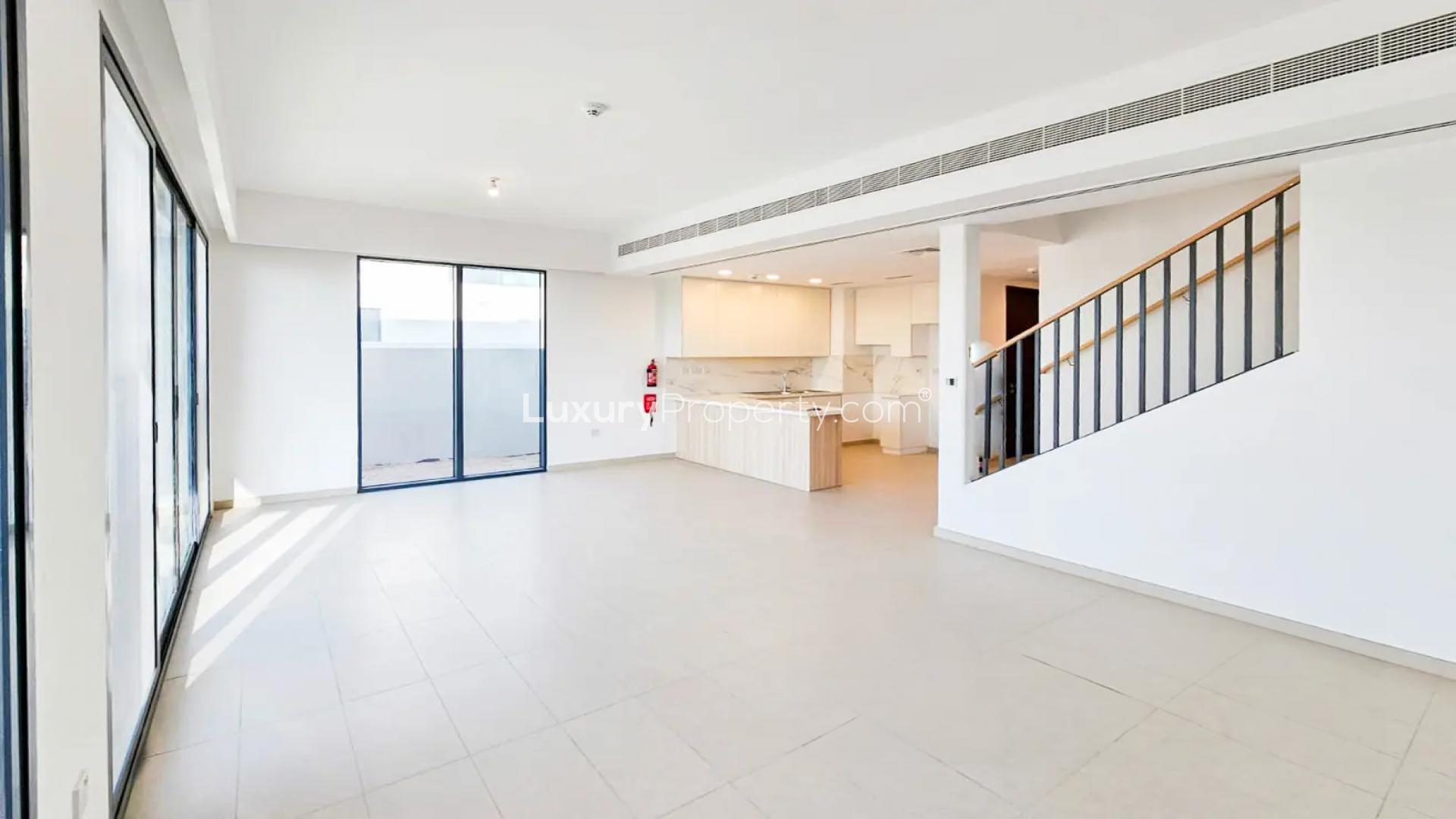 Bright living room with large windows in Cherrywoods townhouse, Dubai Land