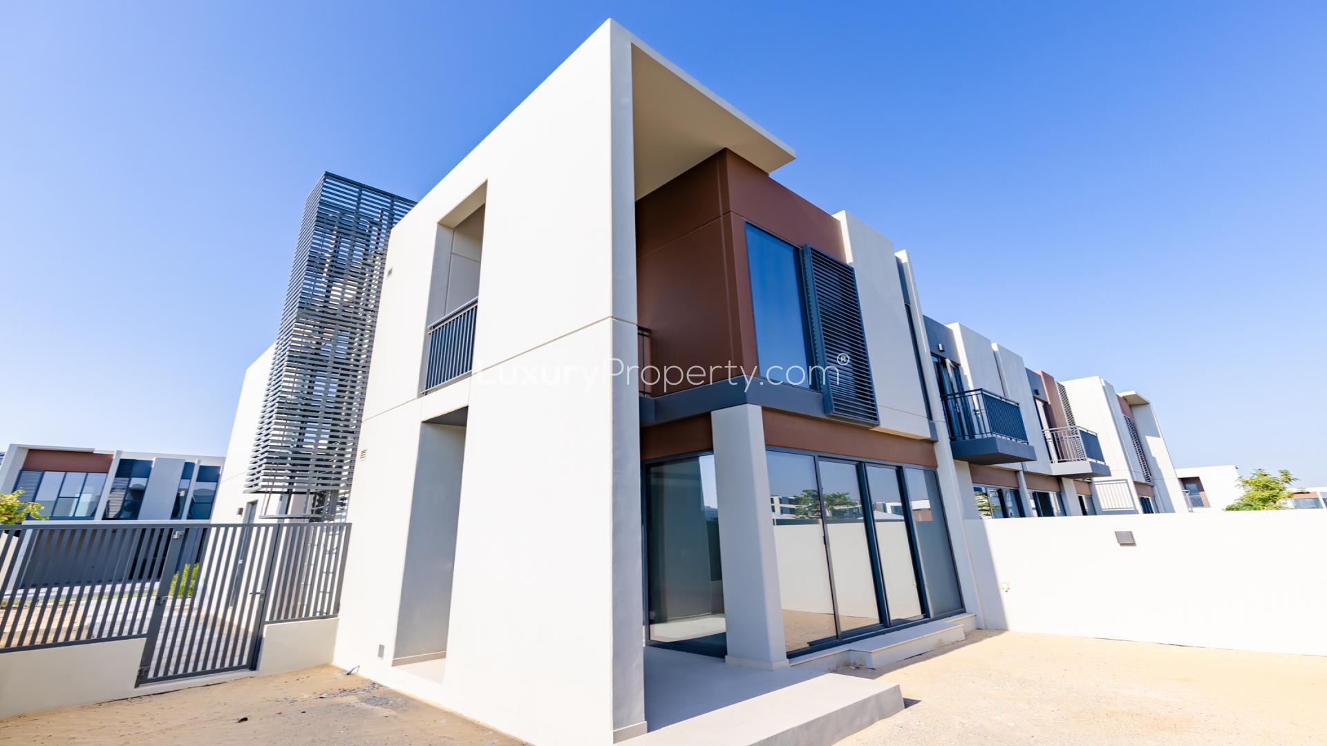 Modern kitchen and living area in Cherrywoods townhouse, Dubai Land, with large windows