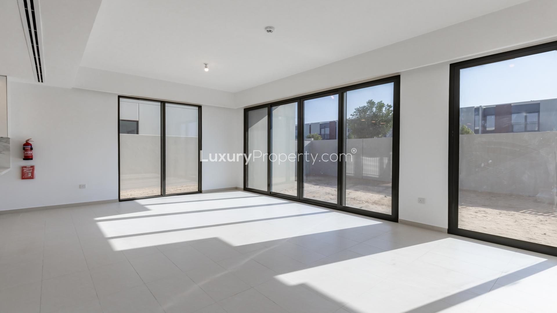 Bright kitchen in Cherrywoods townhouse, Dubai Land, with modern design and large windows