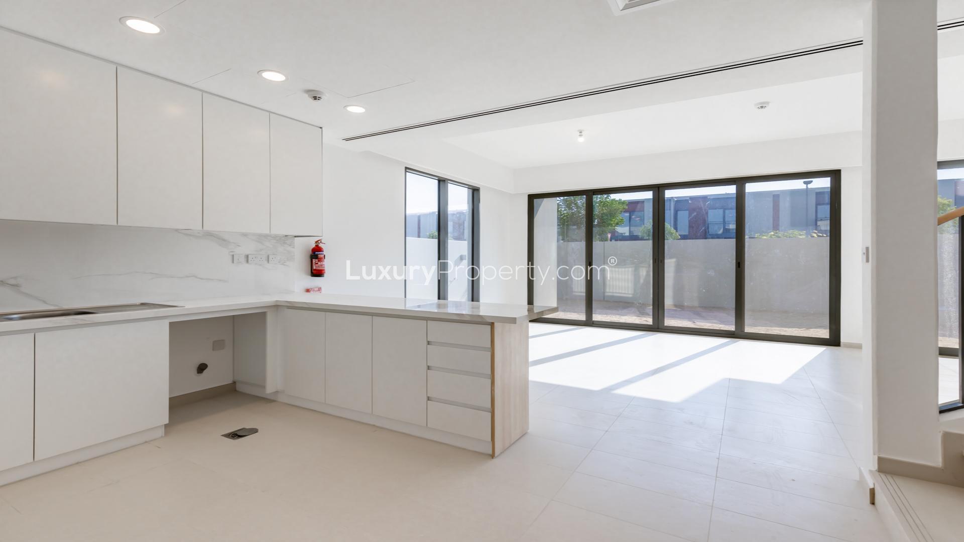 Open-plan living area in Cherrywoods townhouse, featuring modern kitchen and staircase