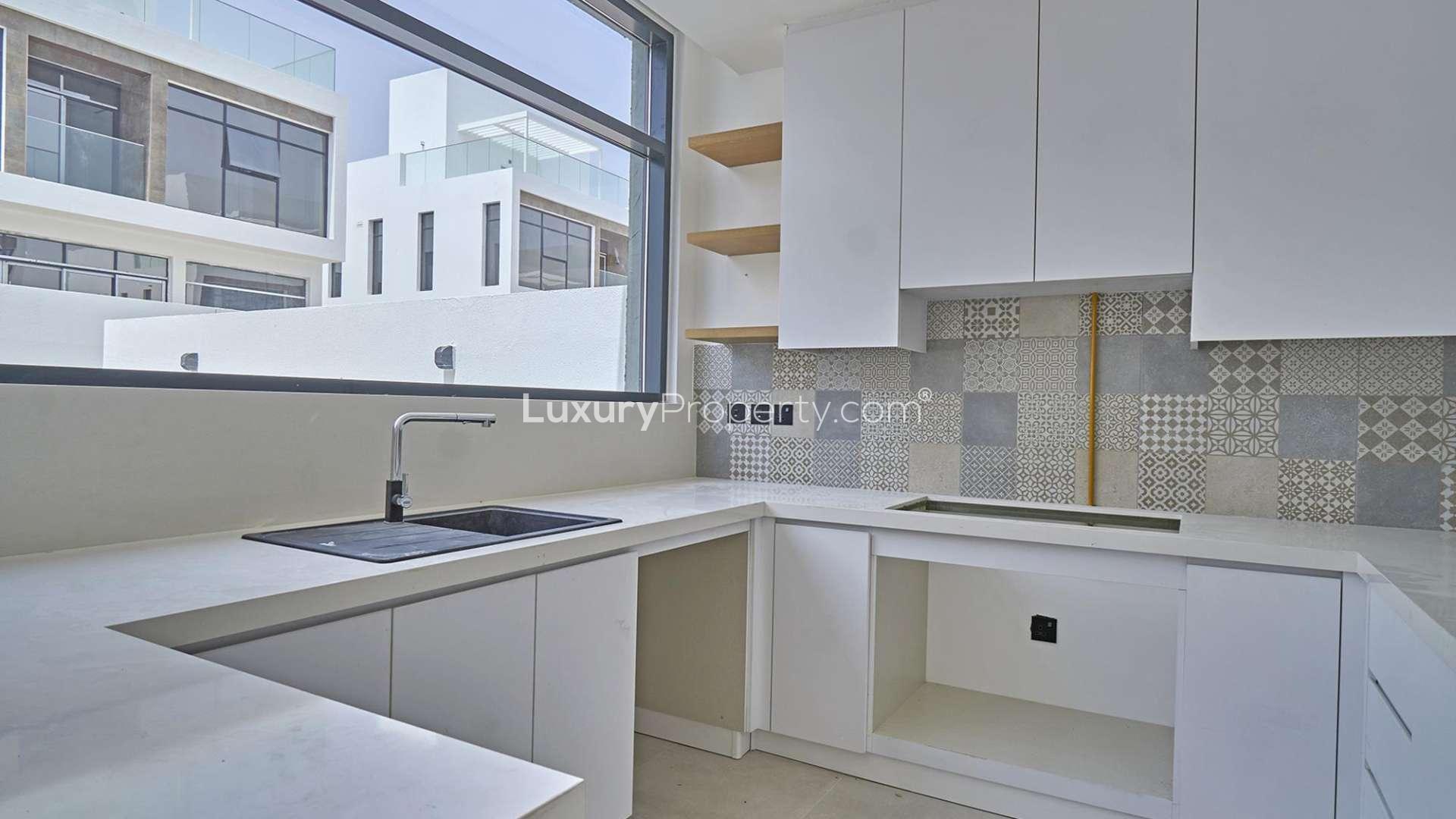 N/A,Modern kitchen in Jumeirah Luxury townhouse, featuring sleek white cabinets and patterned tiles