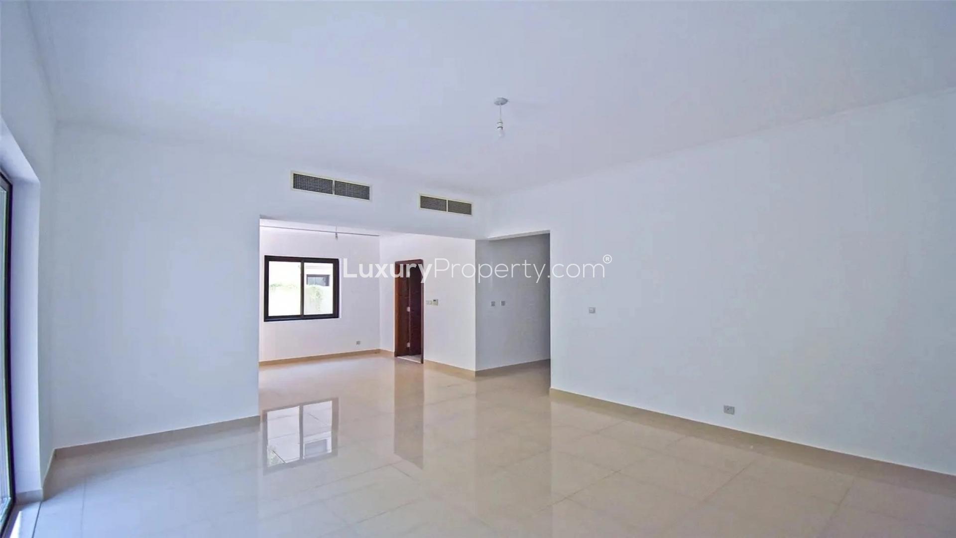 Empty living room with large window overlooking landscaped garden in Samara villa