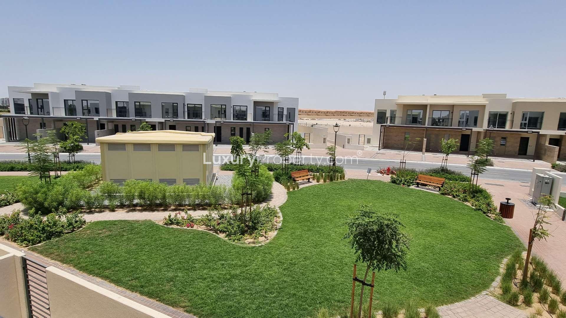 "Modern townhouse exterior with carport in Camelia, Arabian Ranches 2, for rent.",Townhouse exterior in Camelia, Arabian Ranches 2 with landscaped garden view, ready for rent