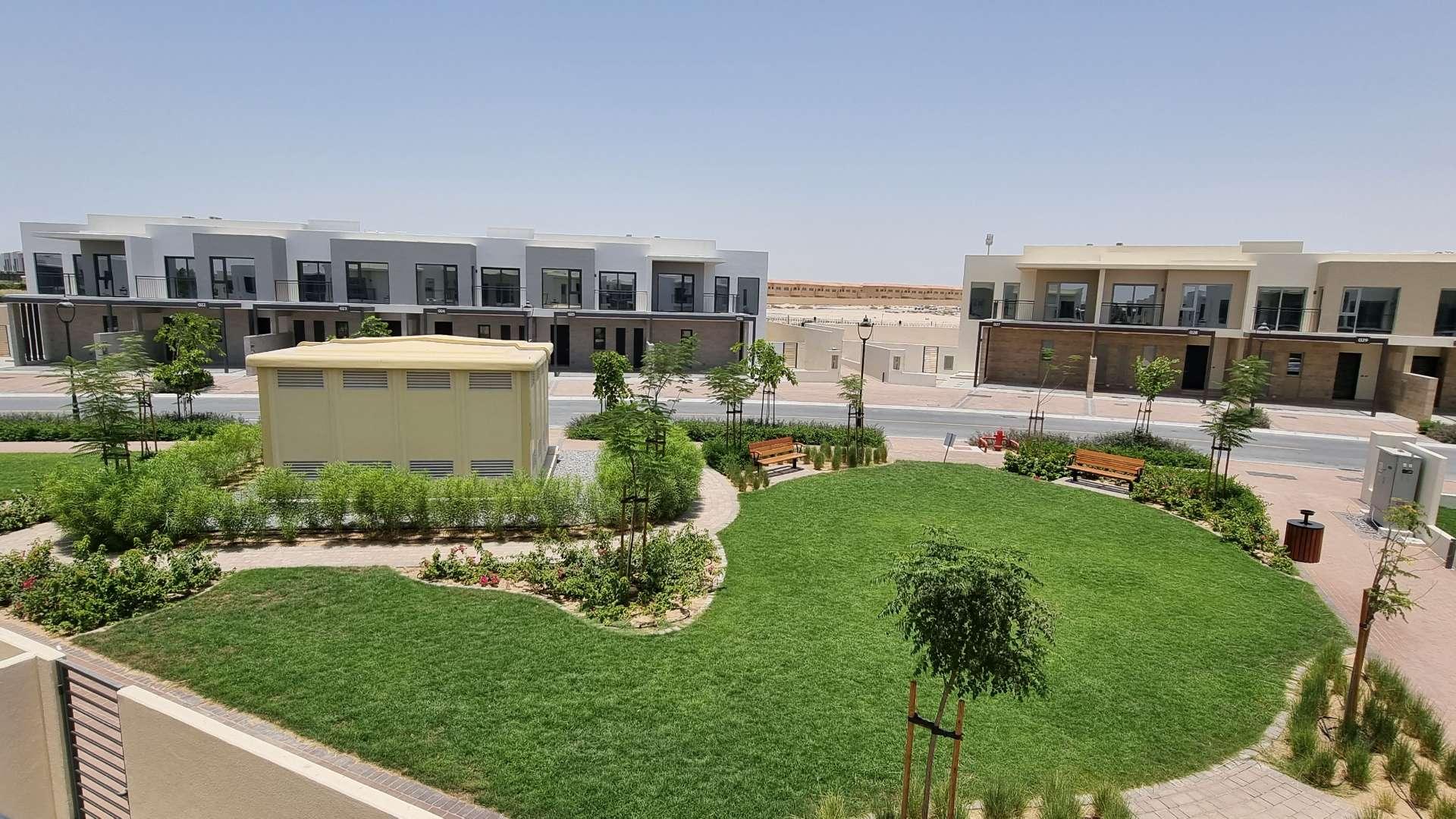 "Modern townhouse exterior with carport in Camelia, Arabian Ranches 2, for rent.",Townhouse exterior in Camelia, Arabian Ranches 2 with landscaped garden view, ready for rent