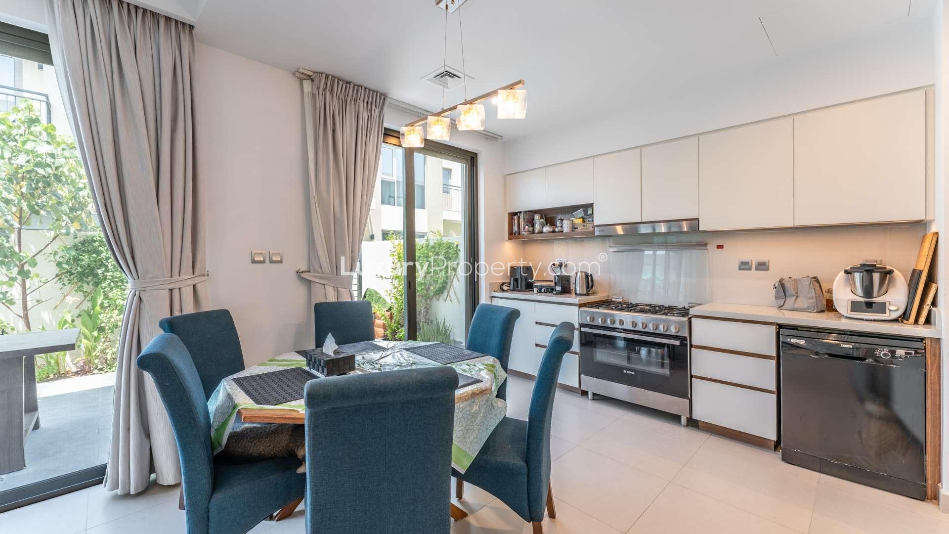 Modern kitchen and dining area in Arabian Ranches 2 townhome, Camelia sub-community