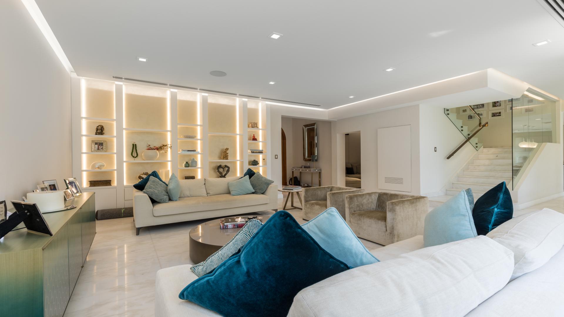 Luxurious living room in Canal Cove Villa, Palm Jumeirah, featuring elegant decor and seating