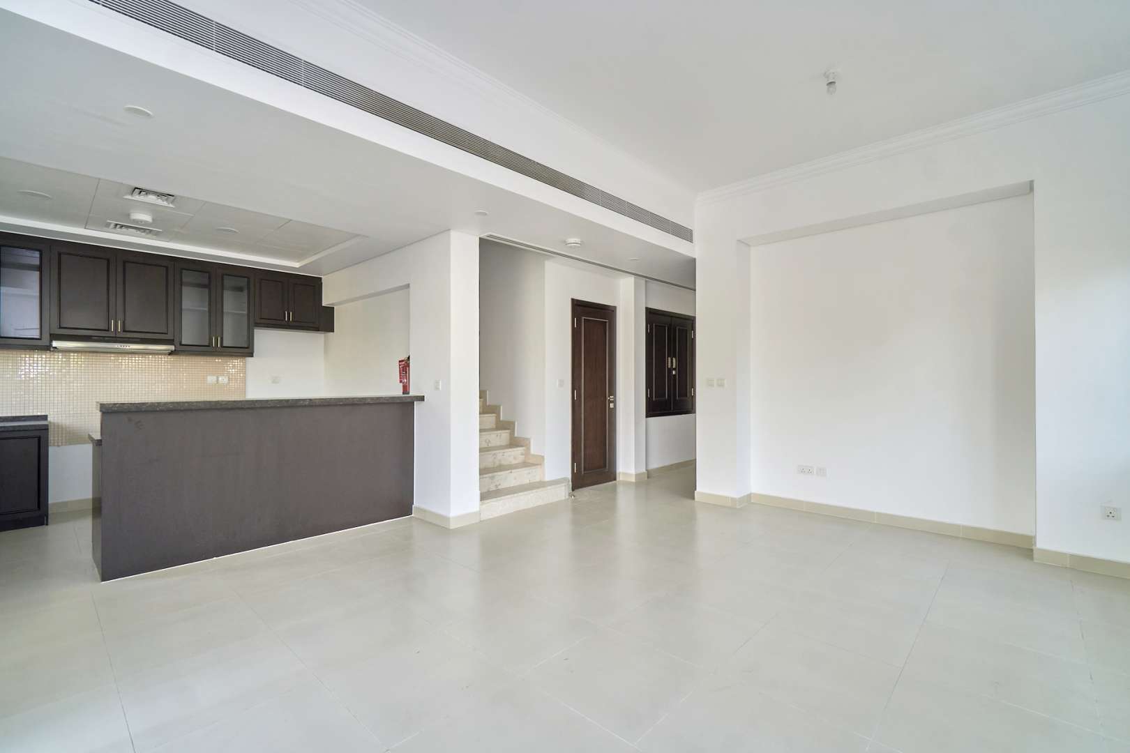 Modern kitchen in 4-bedroom townhouse, Casa Viva, Serena, with dark cabinets and spacious counters