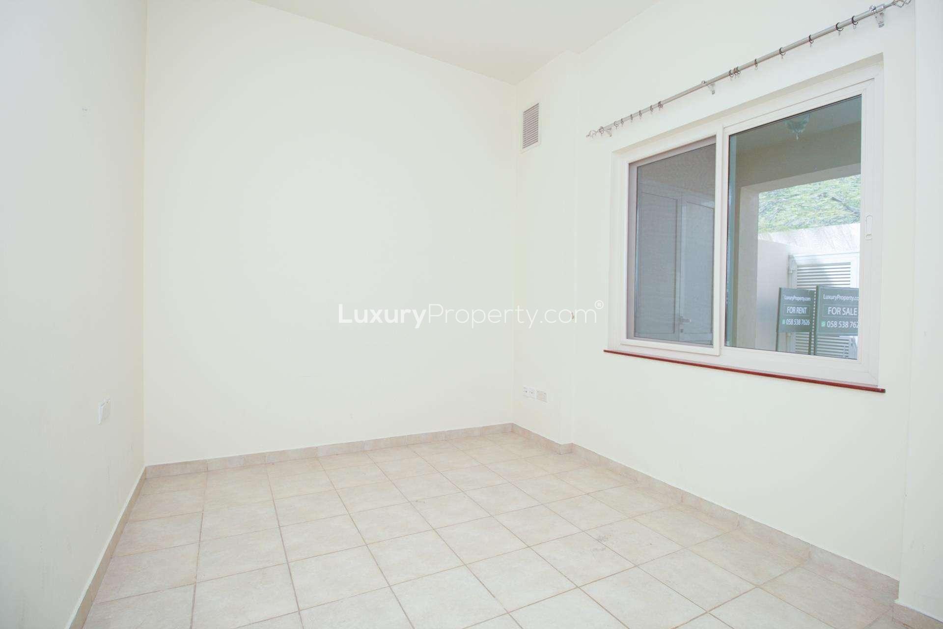 Bright room with tiled floor and glass doors in Victory Heights townhouse, Dubai