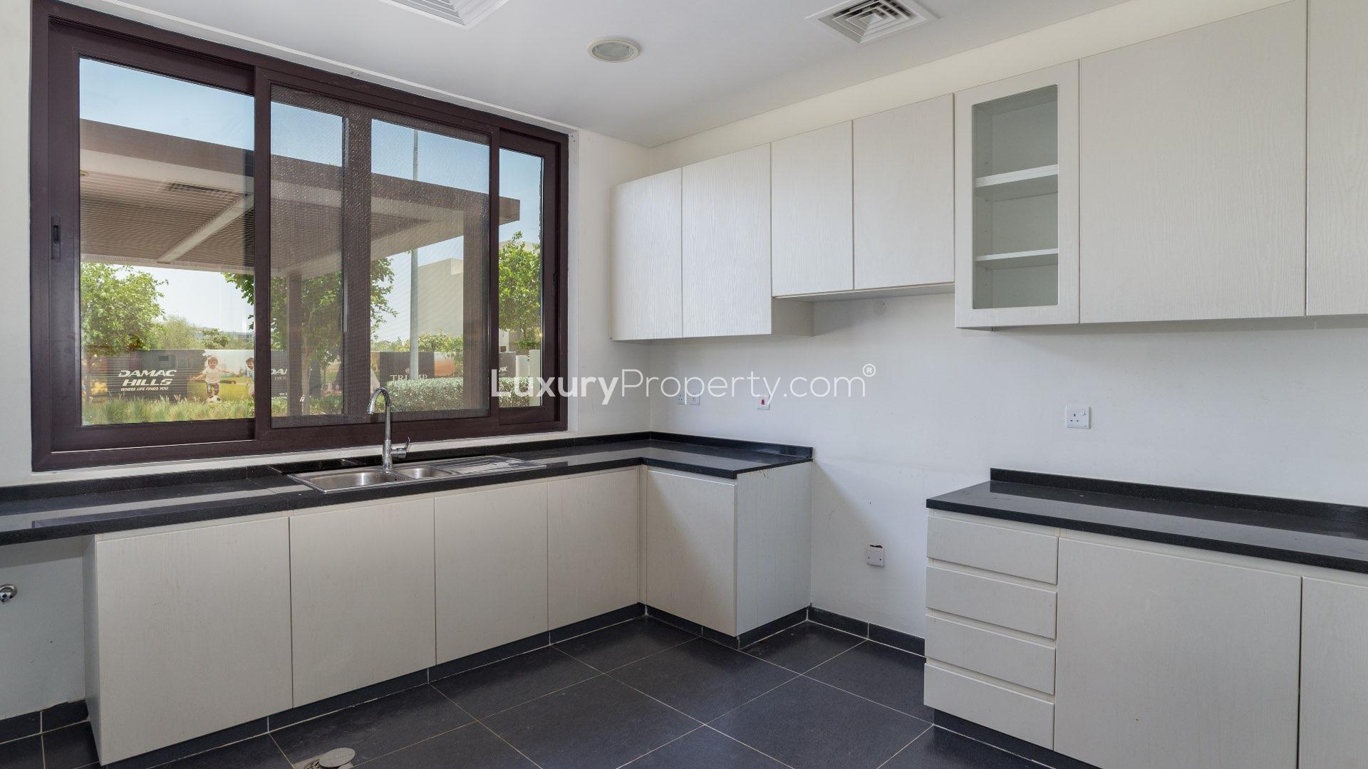 Bright living area with large windows in Damac Hills townhouse for rent