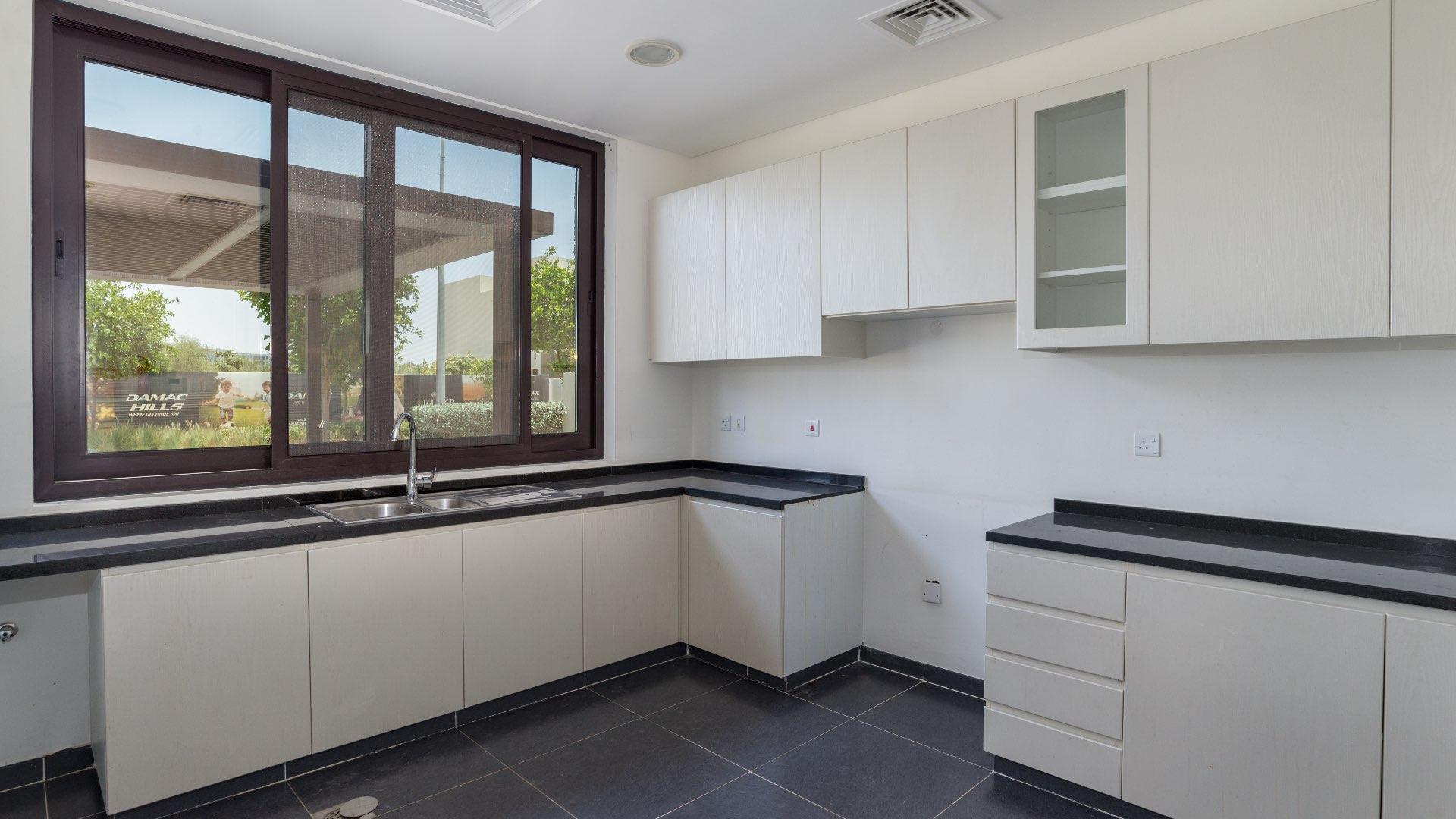 Bright living area with large windows in Damac Hills townhouse for rent