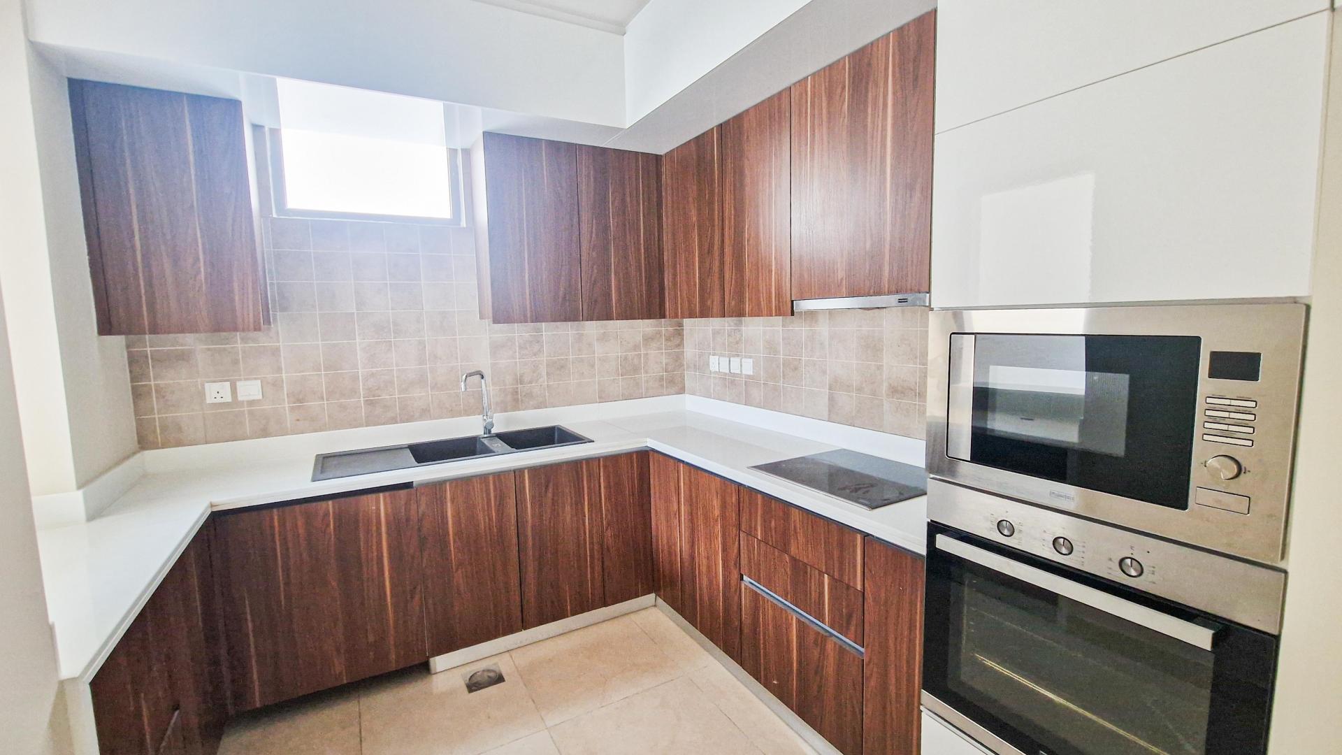 Empty living area with tiled floor in Murano townhouse, Al Furjan, available for rent