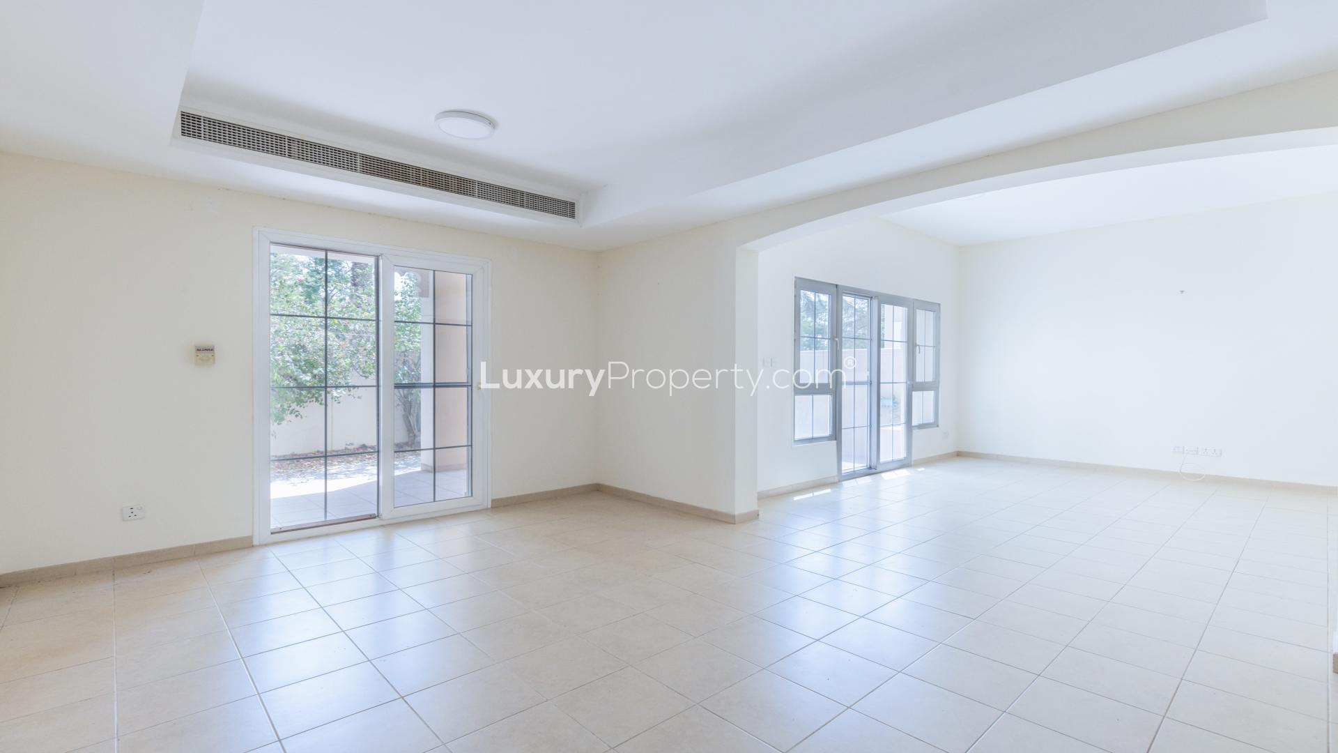 "Charming balcony view from 4-bedroom villa in Al Reem, Arabian Ranches for rent.",Spacious living room with large windows in Al Reem villa, Arabian Ranches