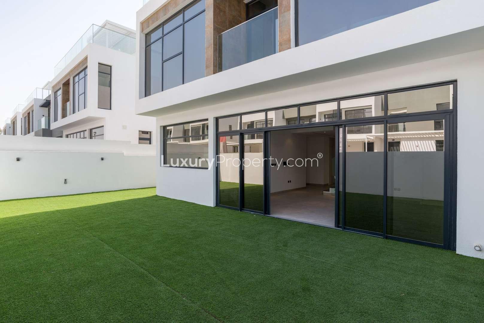 Modern townhouse exterior with spacious lawn in Jumeirah Luxury, Jumeirah Golf Estates