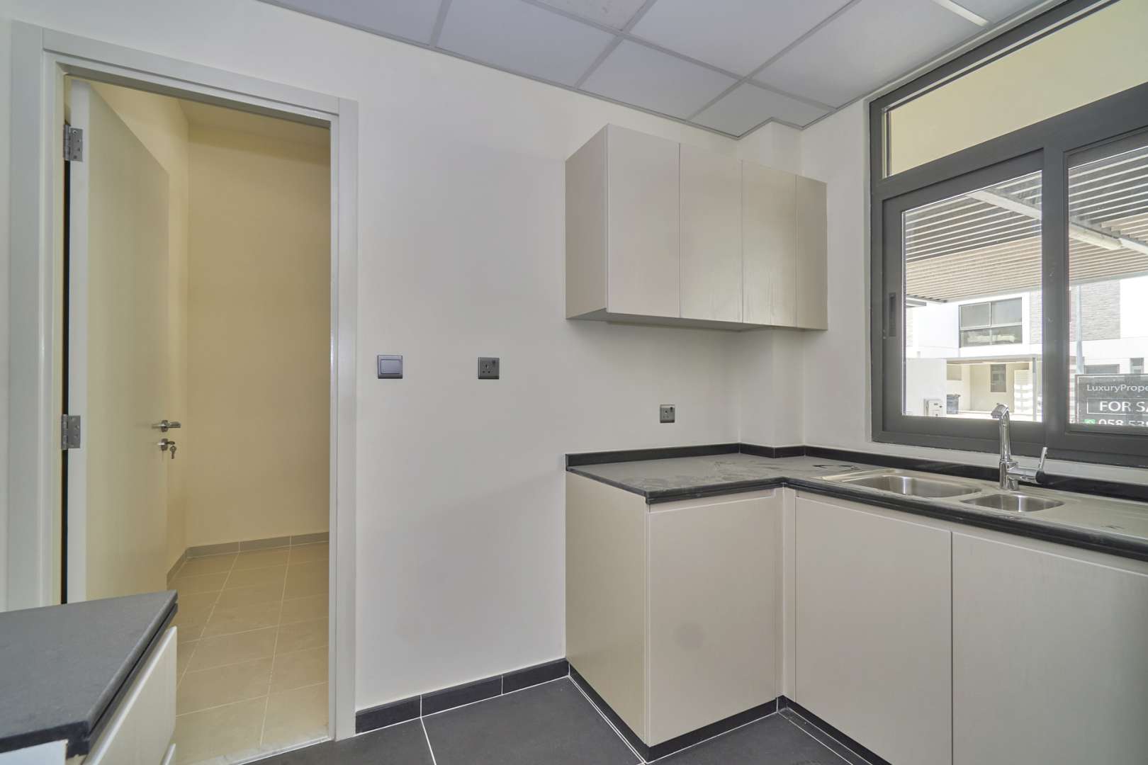 Modern 4-bedroom townhouse exterior for rent in Juniper, Damac Hills 2, Akoya community