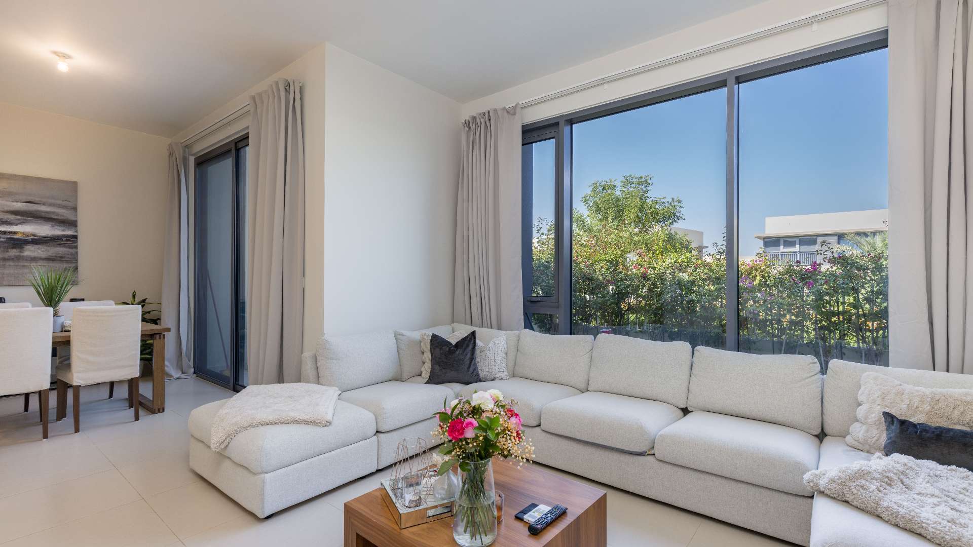 Living room in 4-bedroom townhouse, Maple, Dubai Hills Estate, with modern decor and garden view