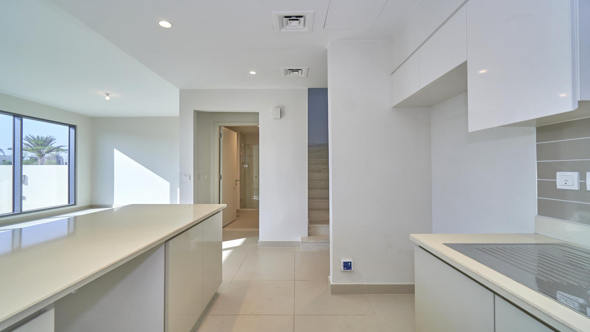 Modern kitchen and living area in Dubai Hills Estate townhouse for rent, Maple community