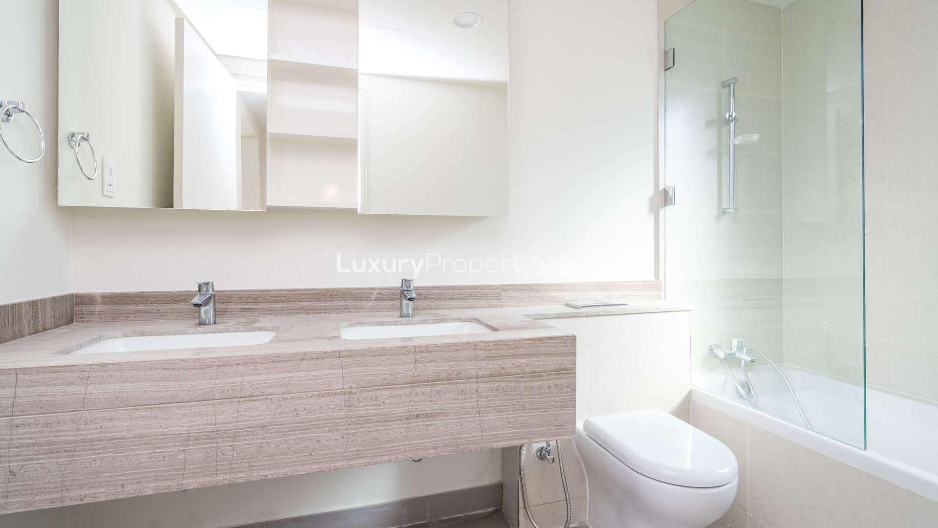 "Bright living room with large windows in Maple at Dubai Hills Estate villa for rent.",Modern bathroom with double sinks in Dubai Hills Estate villa for rent, Maple community